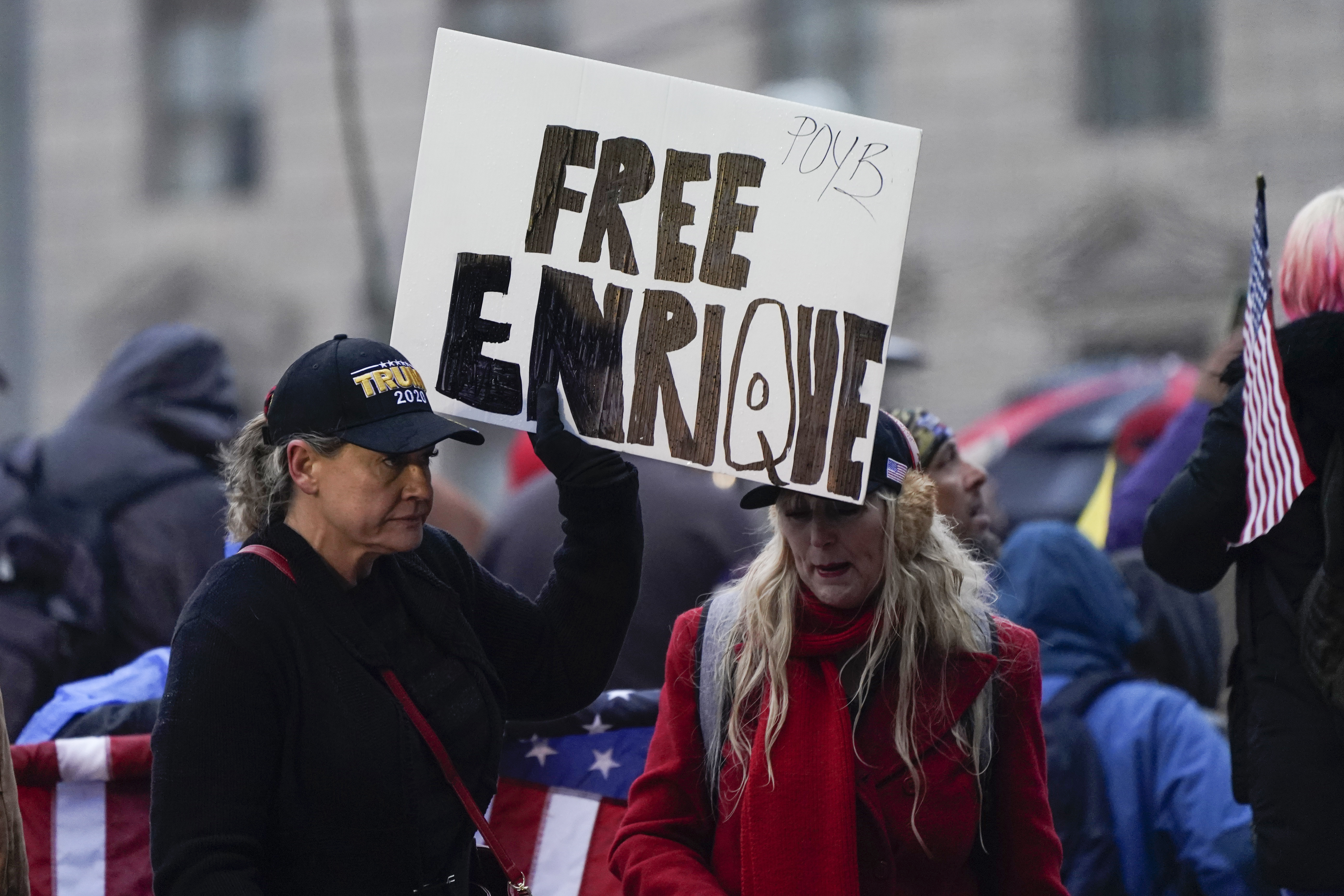 People hold a sign reading ‘Free Enrique’ in reference to Proud Boys leader Henry ‘Enrique’ Tarrio, who was arrested on January 4, 2021 when he arrived back in the District of Columbia, as they attend a rally at Freedom Plaza on Tuesday, January 5, 2021, in Washington, DC
