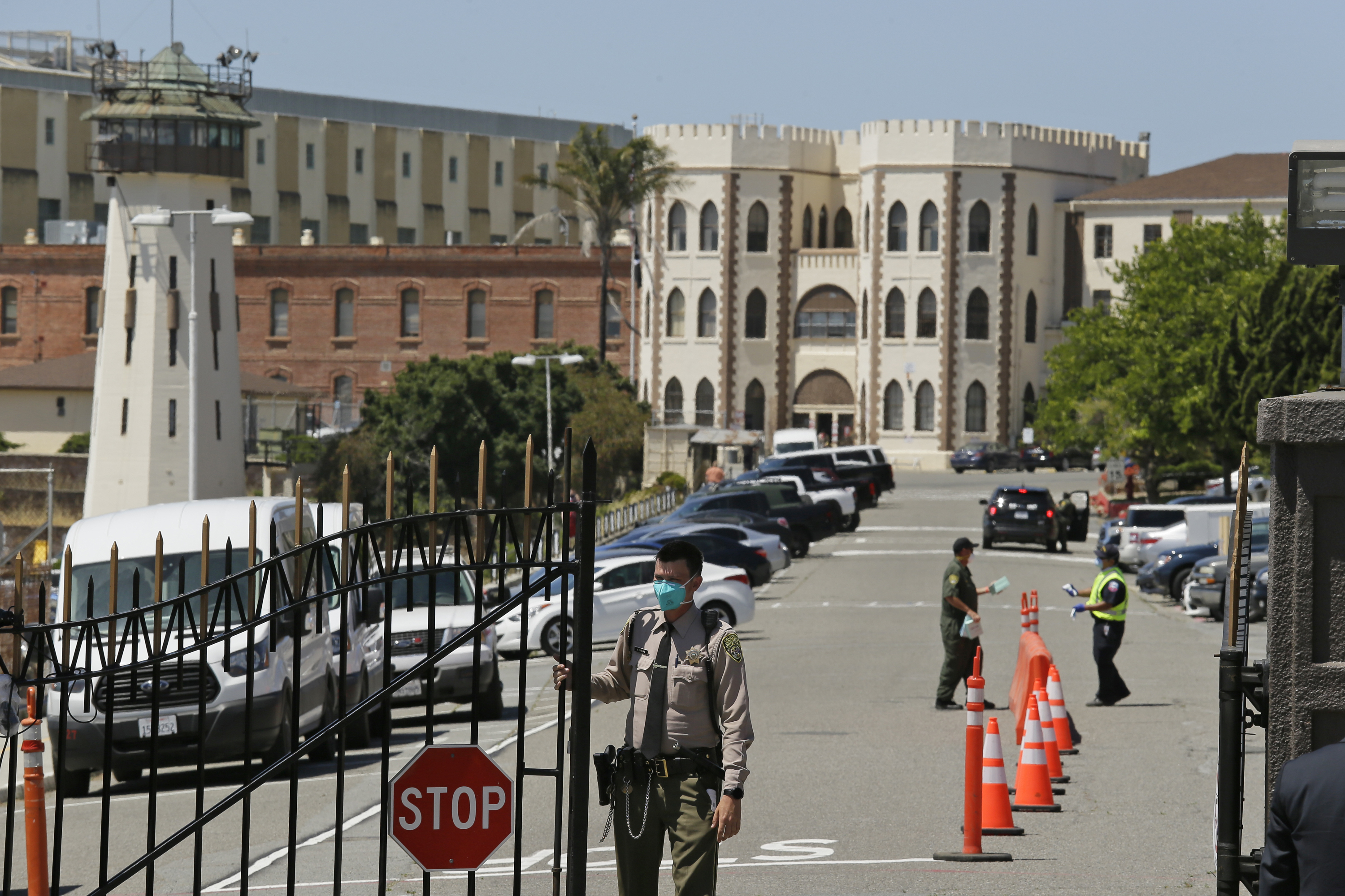 A correctional officer closes the main gate at San Quentin State Prison in California amid the coronavirus pandemic