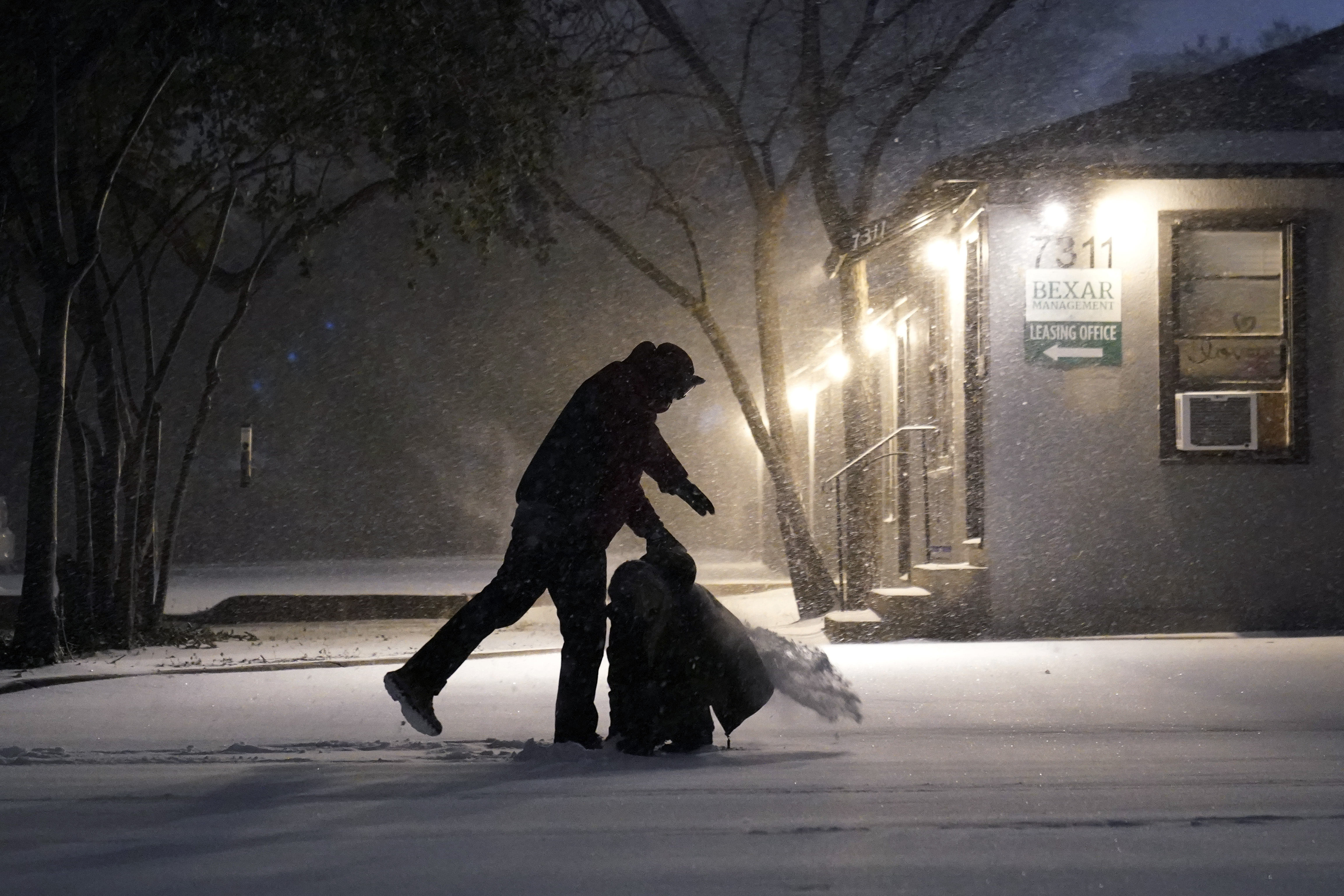 Two people play in the snow in San Antonio, Texas on Sunday, February 14, 2021