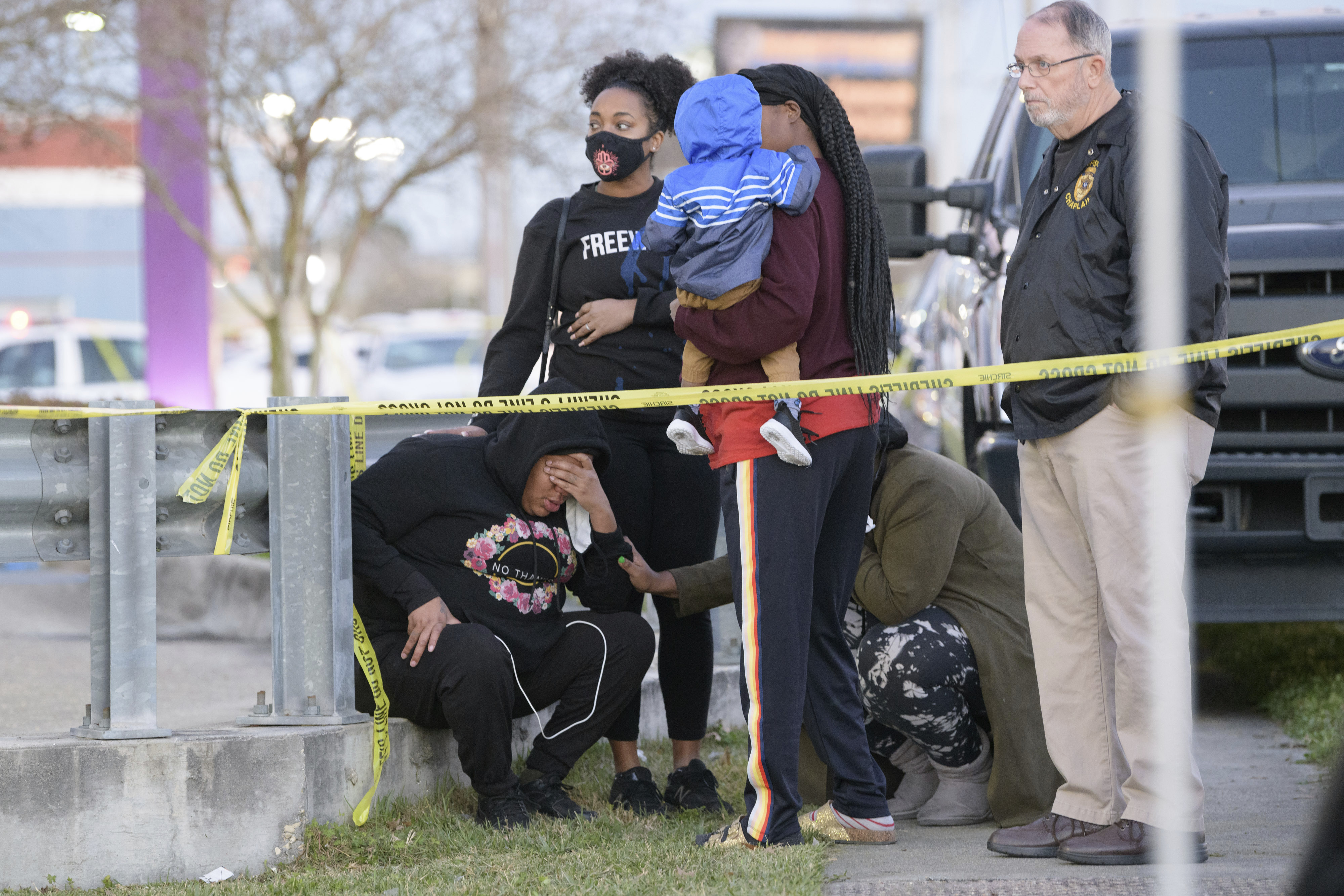 People react at the scene of the shooting