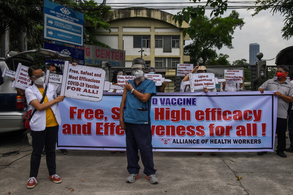 Filipino health workers call on the Duterte administration to give them a vaccine with the safest and highest efficacy rate during a protest outside the Lung Center of the Philippines in Manila earlier this month
