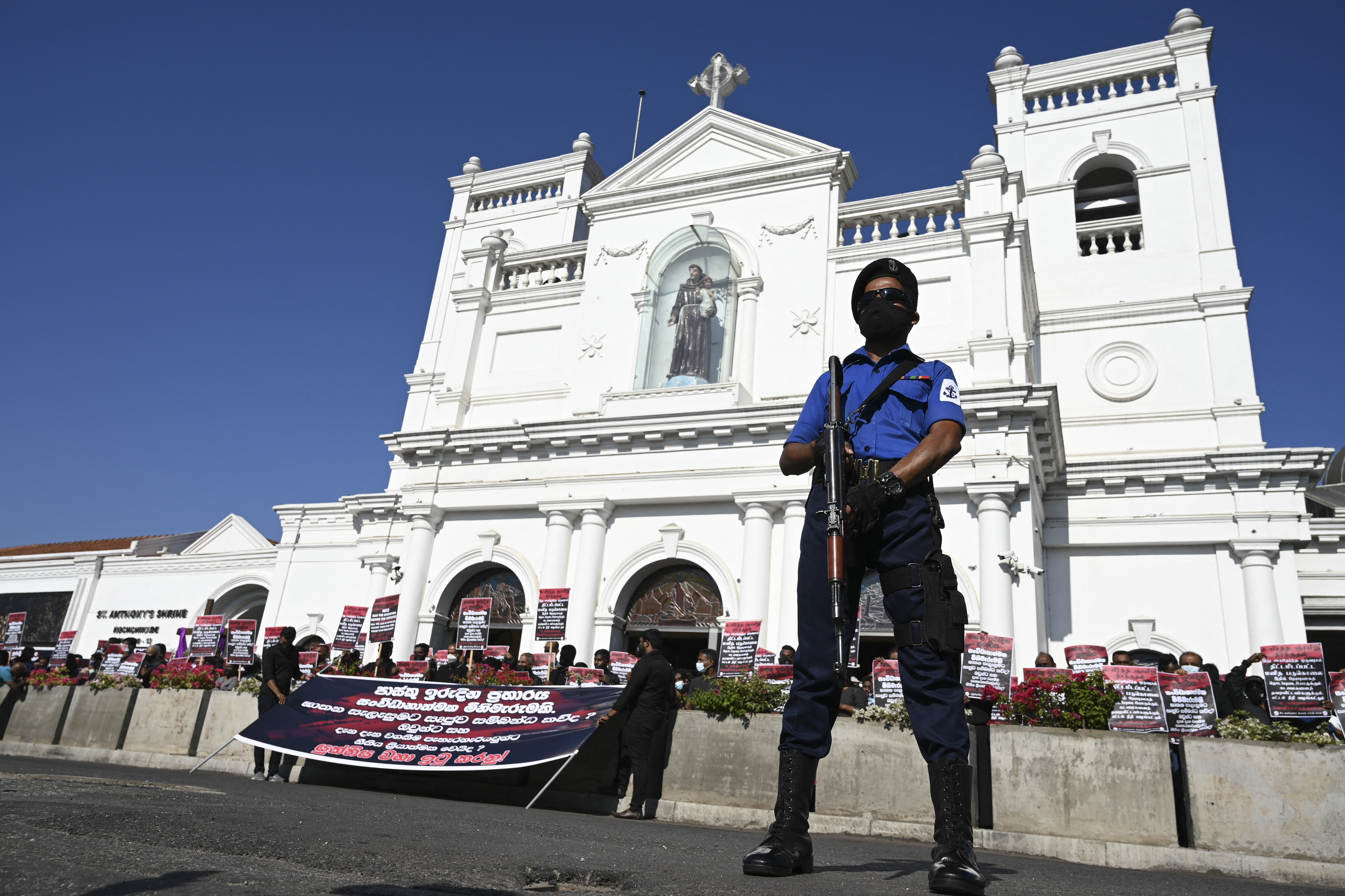 A Navy personnel stands guard as Sri Lankan Catholics take part in a 'Black Sunday' demonstration outside the Saint Anthony's church in Colombo [File: Lakruwan Wanniarachchi/AFP]