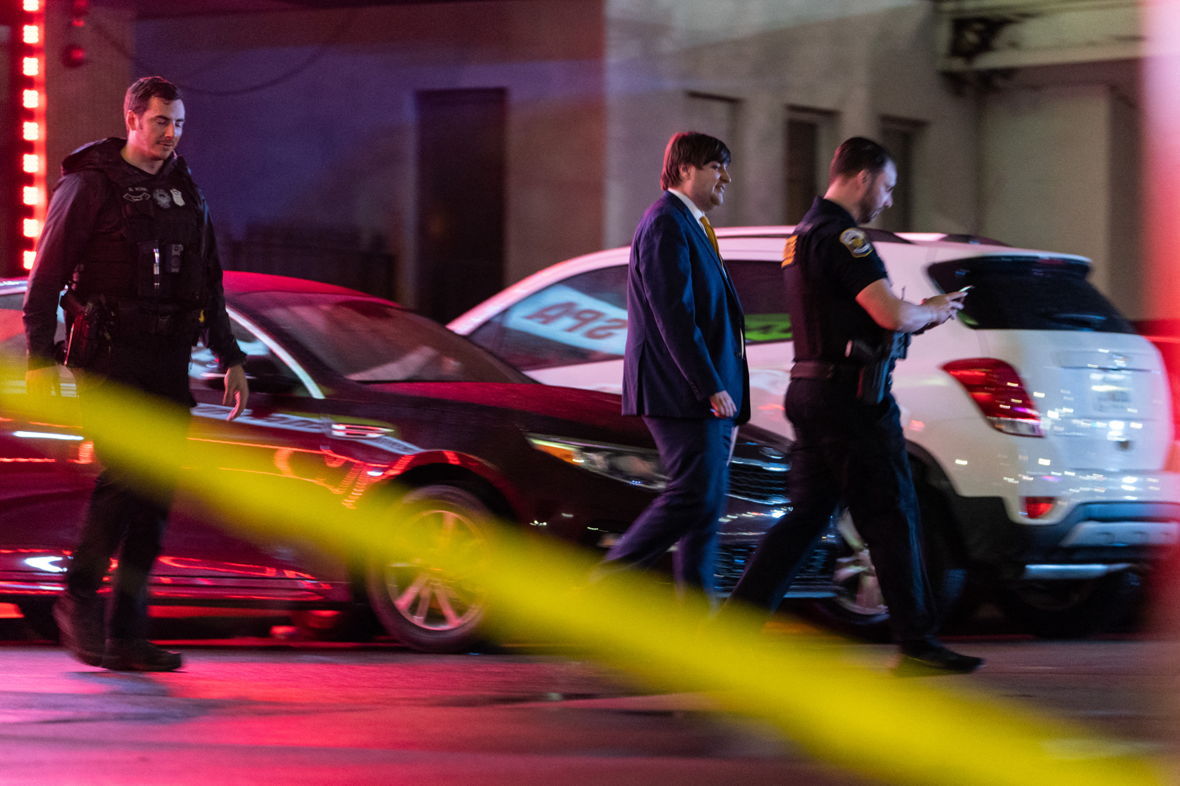 Law enforcement personnel leave a massage parlour where a person was shot and killed on March 16, 2021, in Atlanta, Georgia