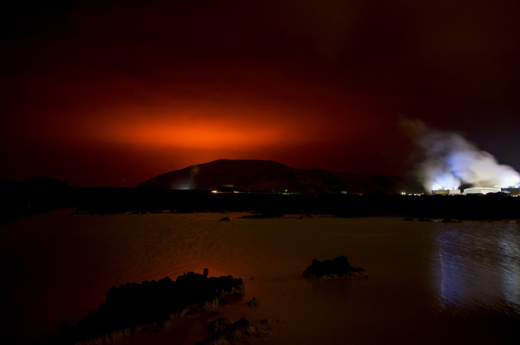 The red shimmer from magma flowing out from the erupting Fagradalsfjall volcano behind the landmark Blue Lagoon, some 45km west of the Icelandic capital Reykjavik on Friday