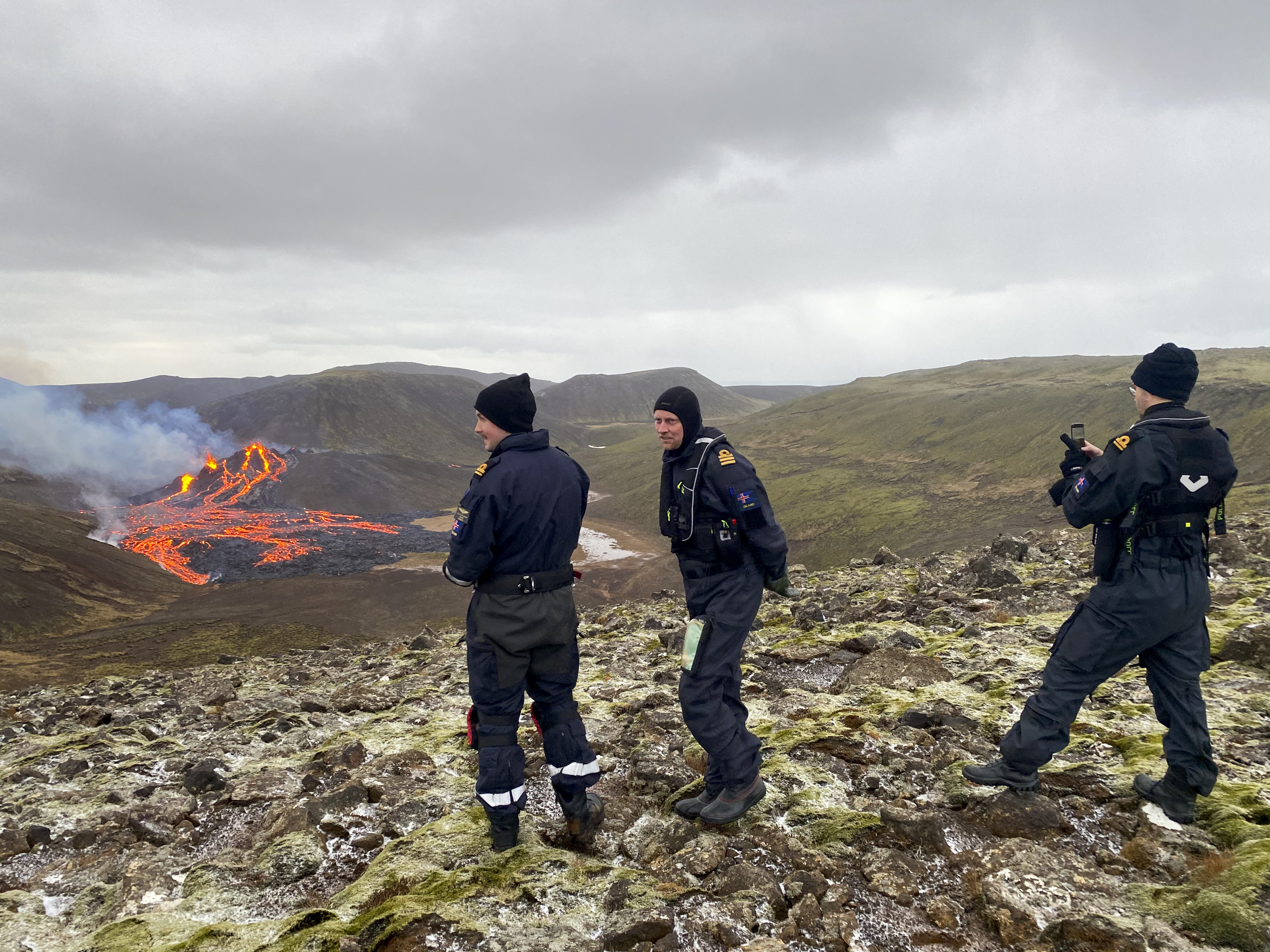 Coast Guard staff inspecting the lava flowing from the erupting Fagradalsfjall volcano [handout/Icelandic Coast Guard via AFP
