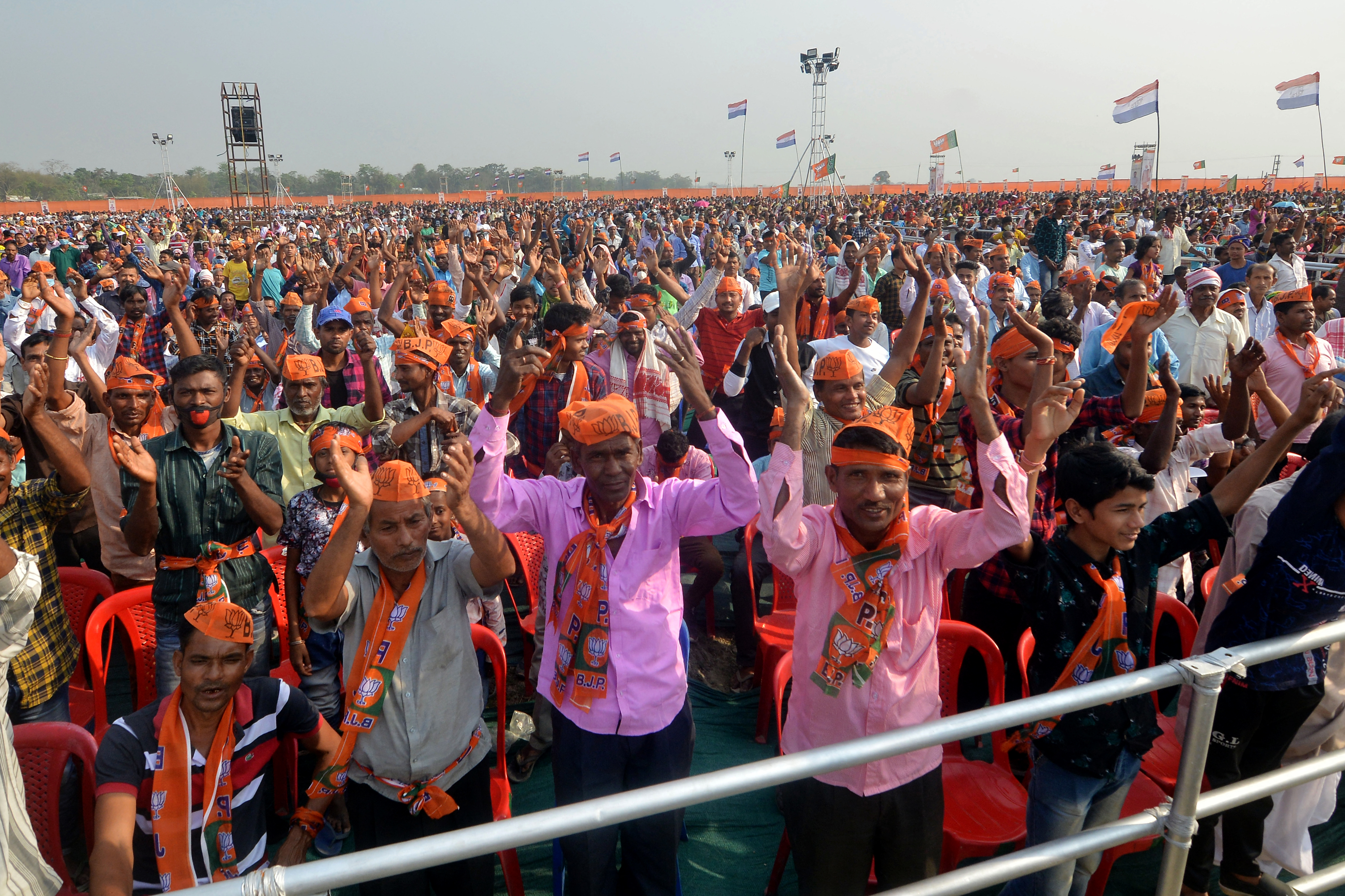 BJP supporters cheer during a public meeting ahead of elections in Sipajhar on the outskirts of Guwahati [Biju Boro/AFP]