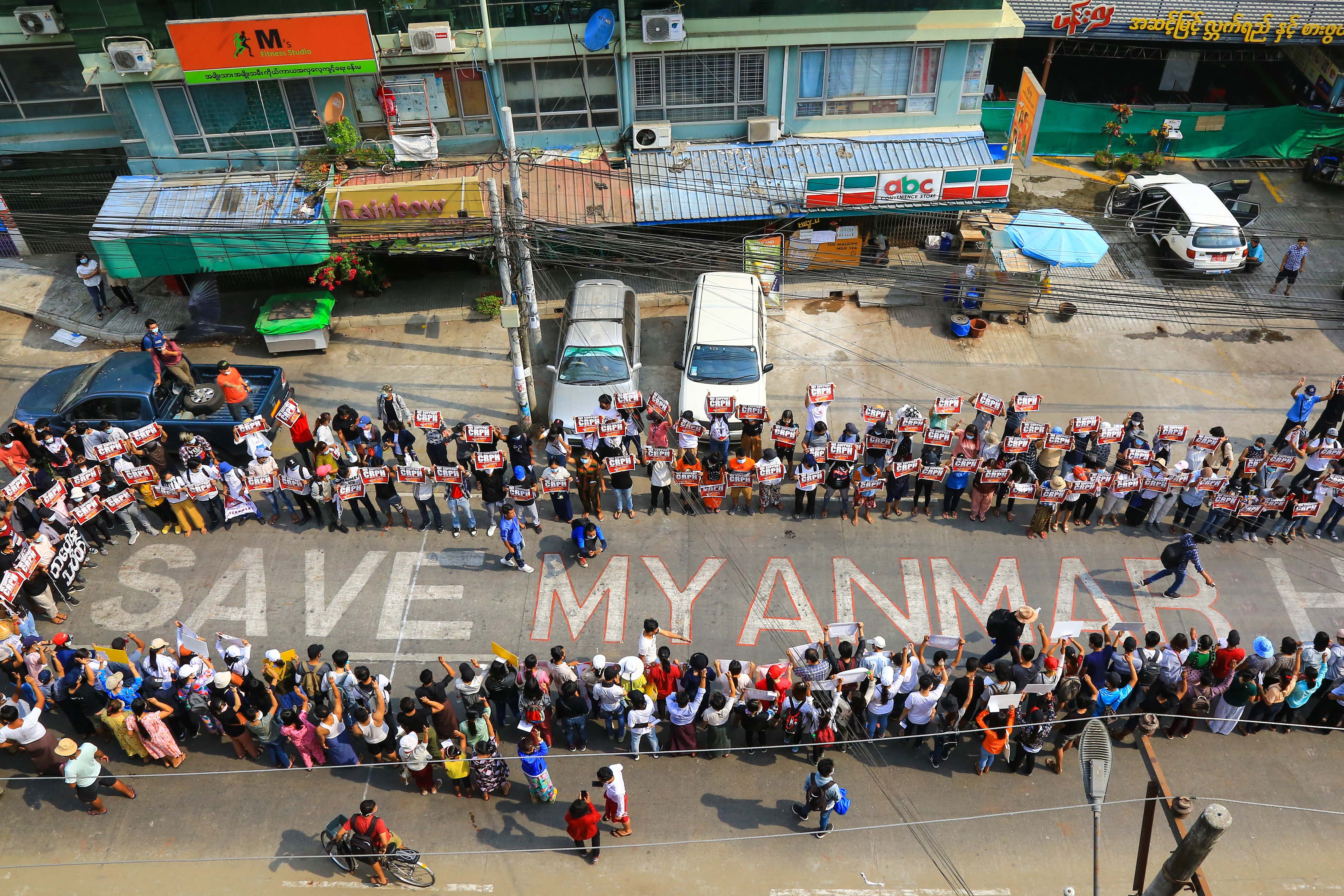 This photo taken and received from an anonymous source via Facebook shows protesters taking part in a demonstration against the military coup in Yangon’s Hlaing township [AFP]