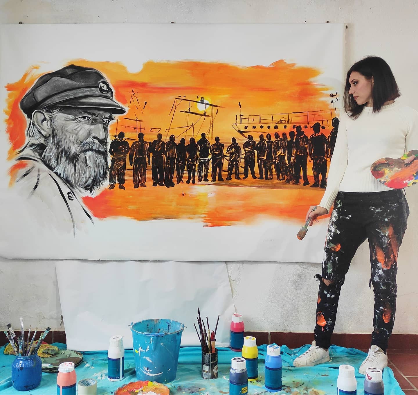 Manuela Marascia painting a picture in honour of the fishermen [courtesy of Manuela Marascia]
