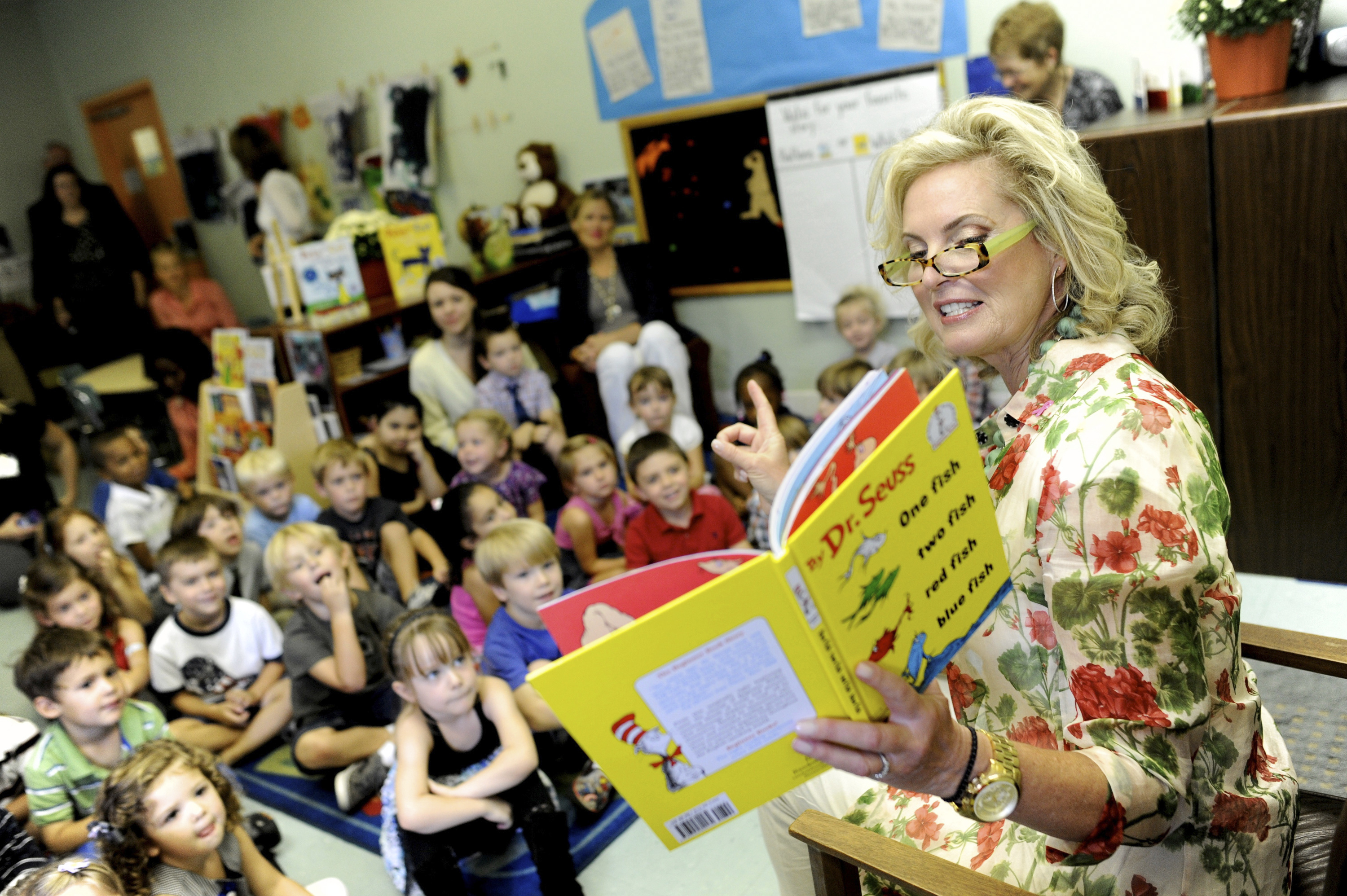 Ann Romney, the wife of US Republican presidential candidate Mitt Romney, reads a Dr Seuss book to a group of young students in 2012