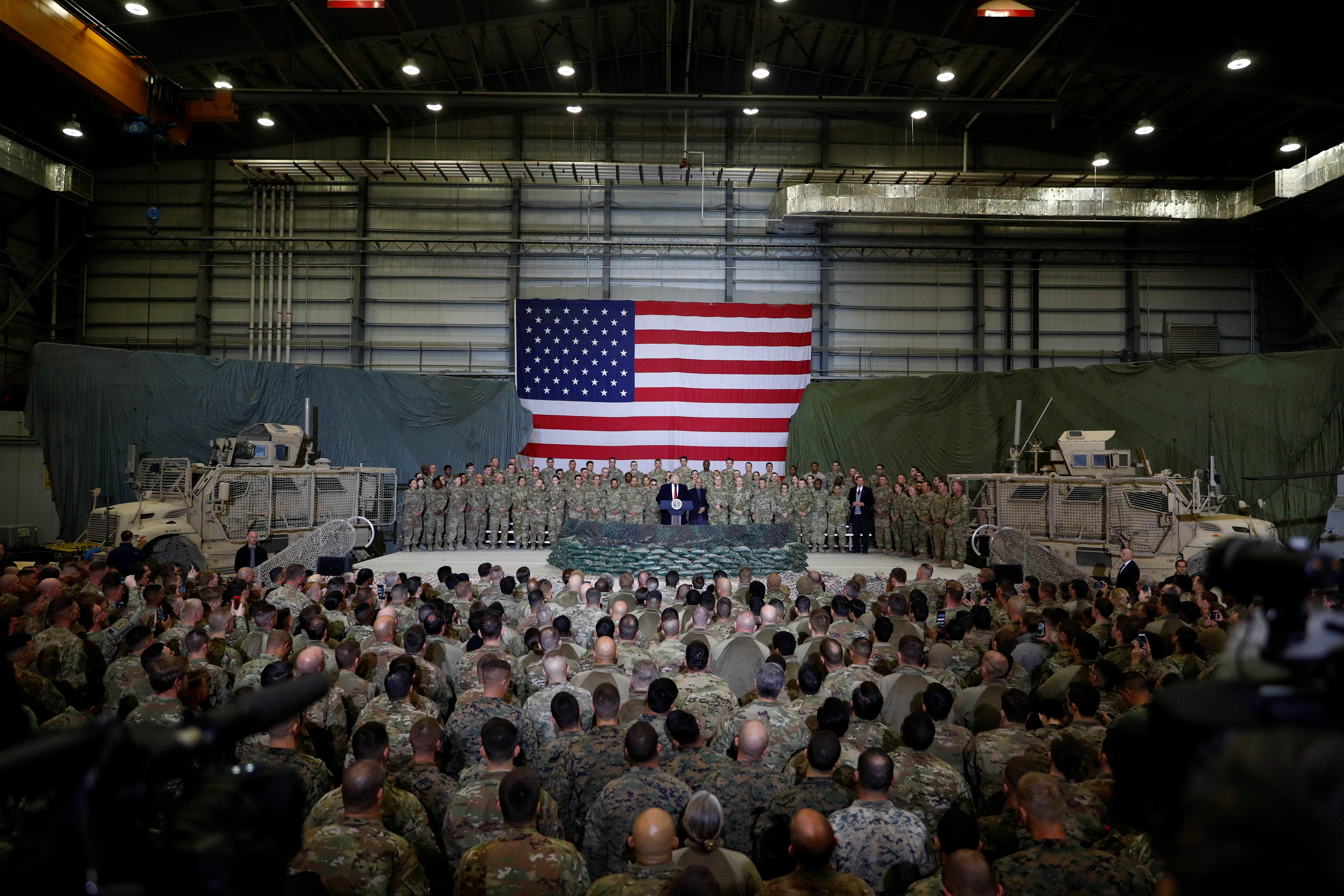 Former President Donald Trump, shown here visiting US troops at Bagram airbase in Afghanistan, negotiated a unilateral ceasefire agreement with the Taliban and promised to withdraw foreign forces from the country by the end of April