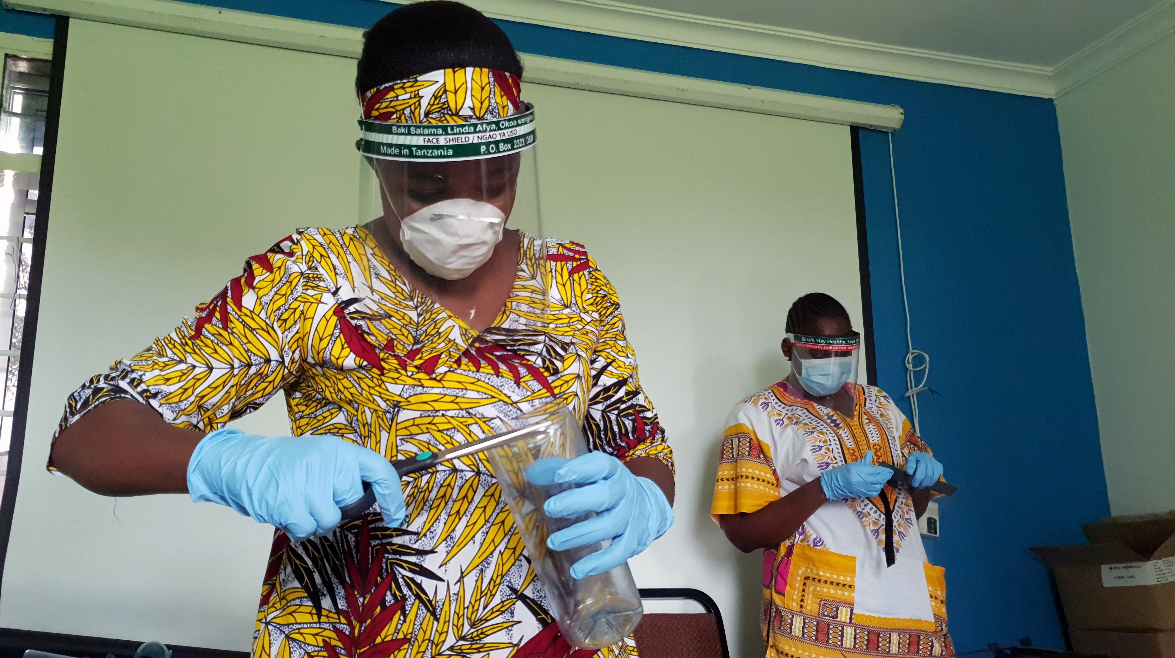 Workers prepare face shields from recycled plastics at the Zaidi Recyclers workshop as a measure to stop the spread of COVID-19 in Dar-es-Salaam