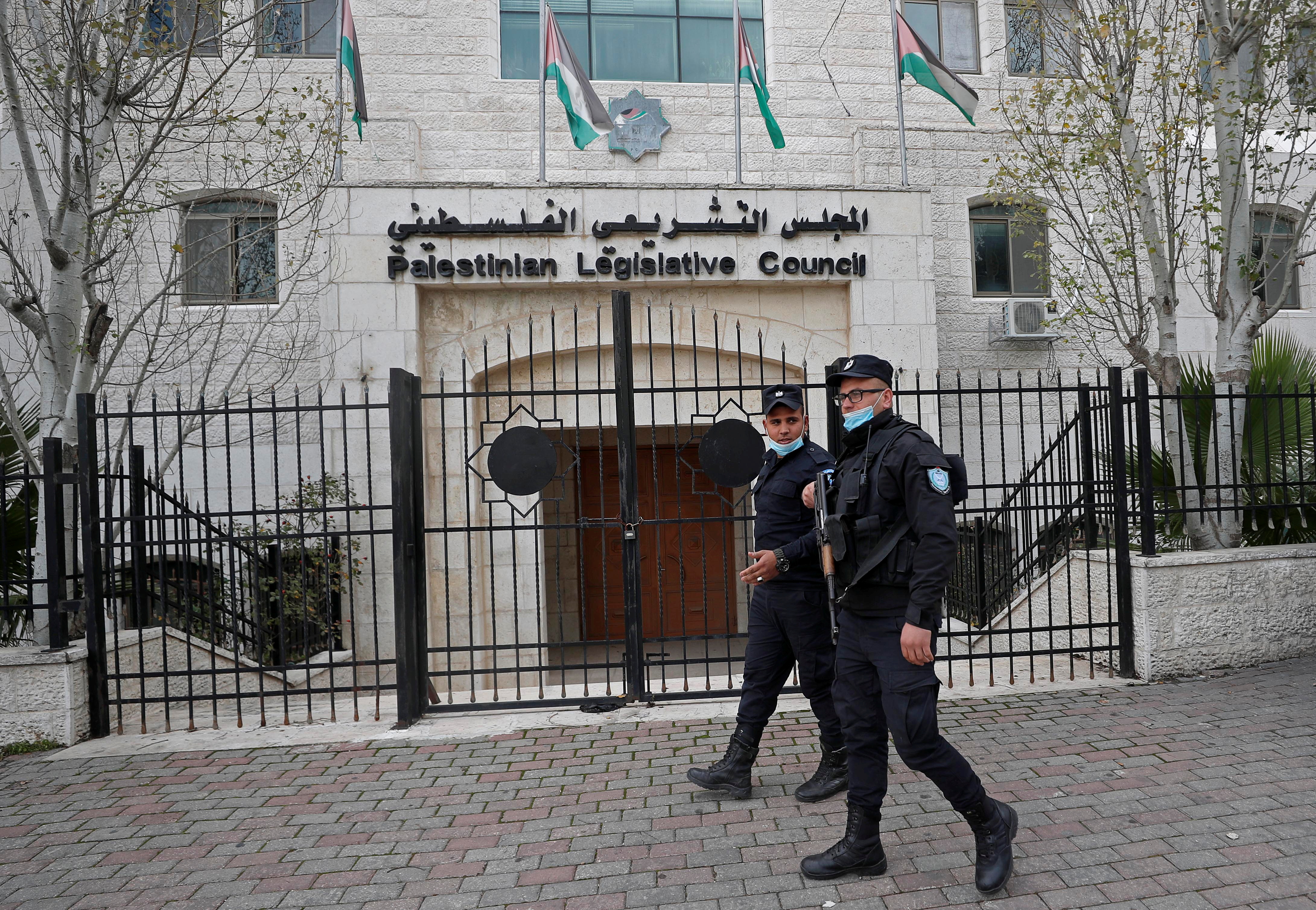 Palestinian policemen guard the Palestinian legislative council in Ramallah, in the Israeli-occupied West Bank on January 16, 2021 [Mohamad Torokman/Reuters]
