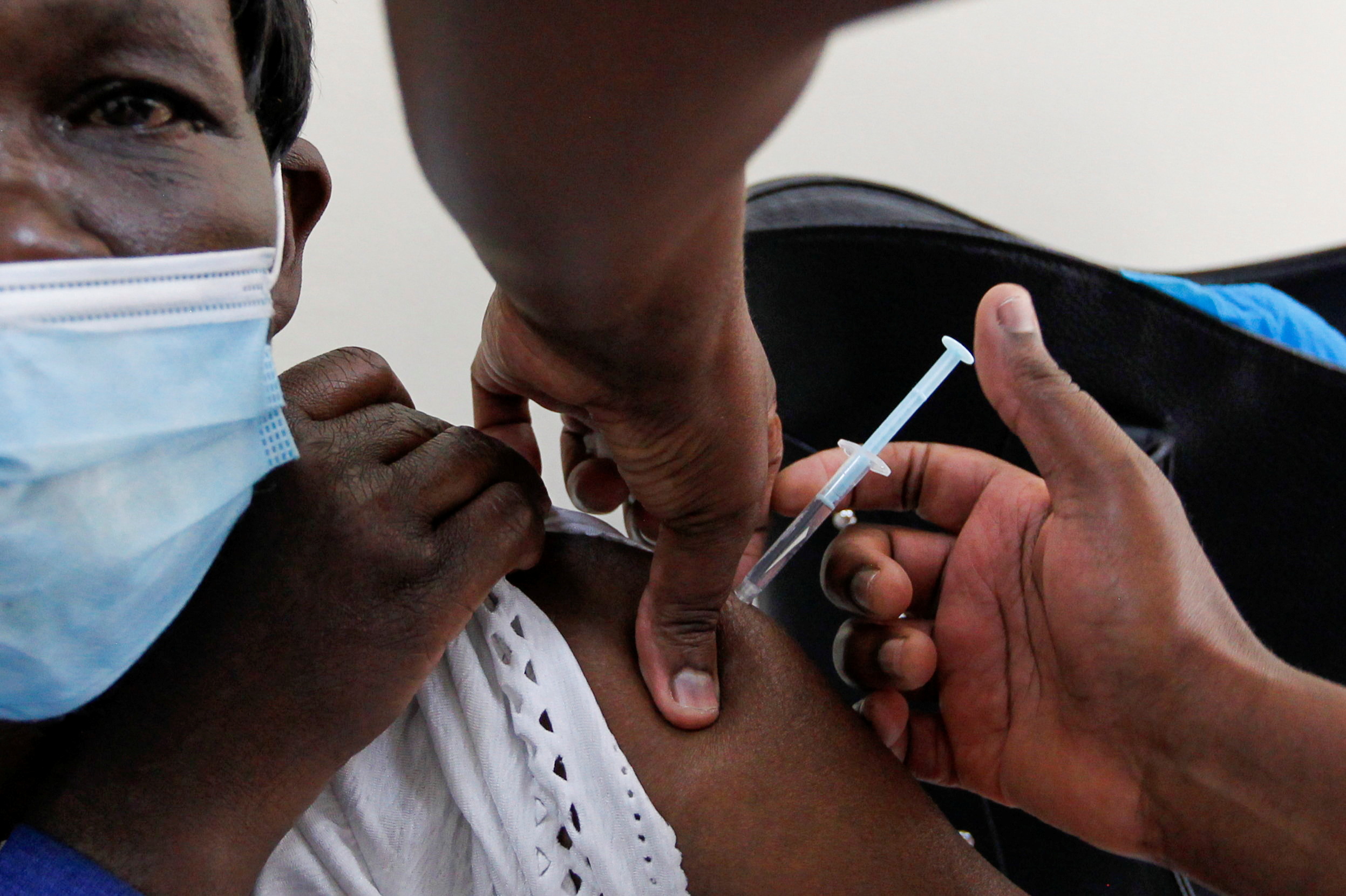 A woman receives the AstraZeneca/Oxford vaccine under the COVAX scheme against coronavirus disease (COVID-19) at the Kenyatta National Hospital in Nairobi