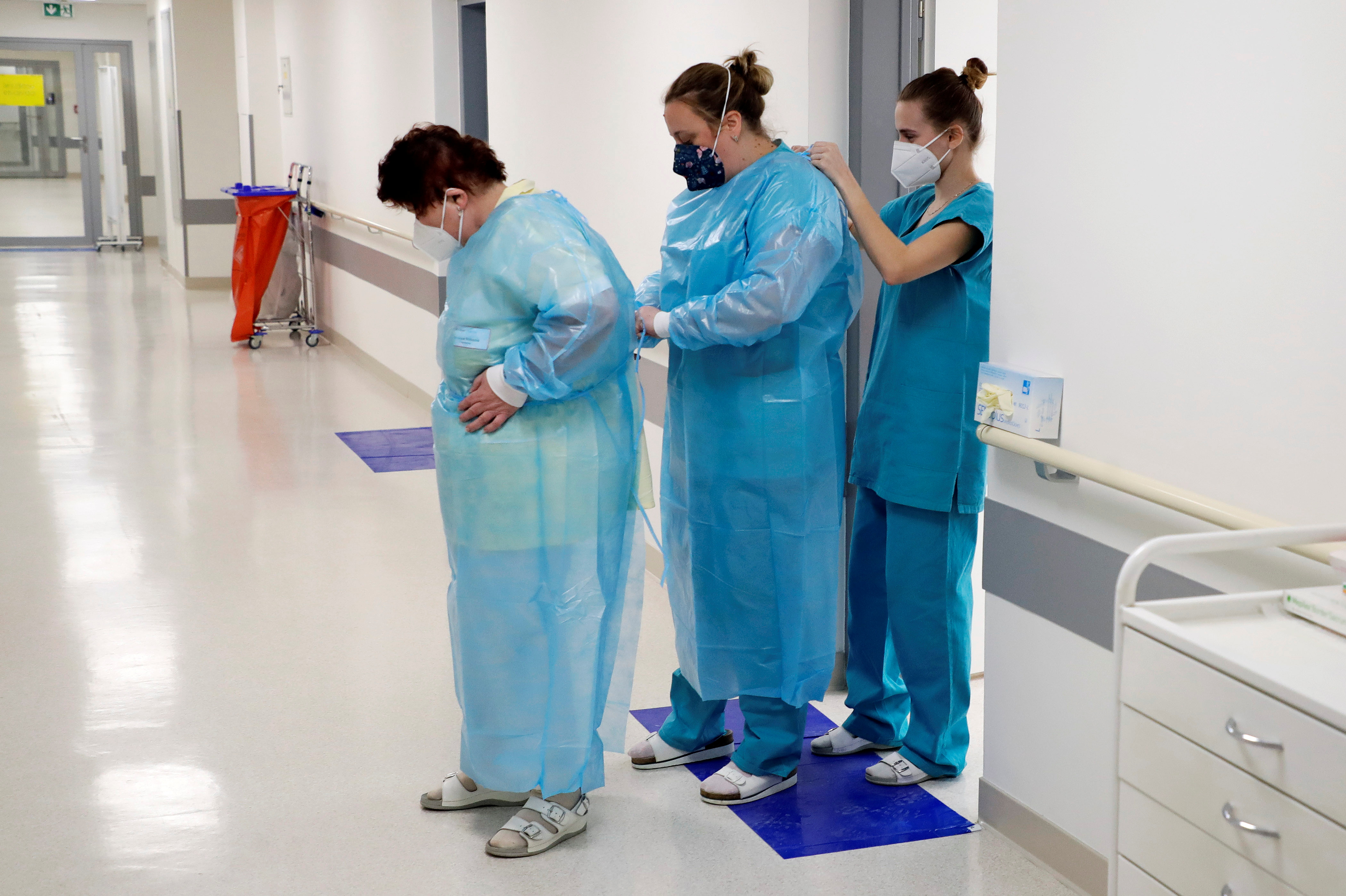 Members of the medical staff put on their protective suits before treating patients inside of the coronavirus disease ward at the Regional Hospital Mlada Boleslav, in the Czech Republic