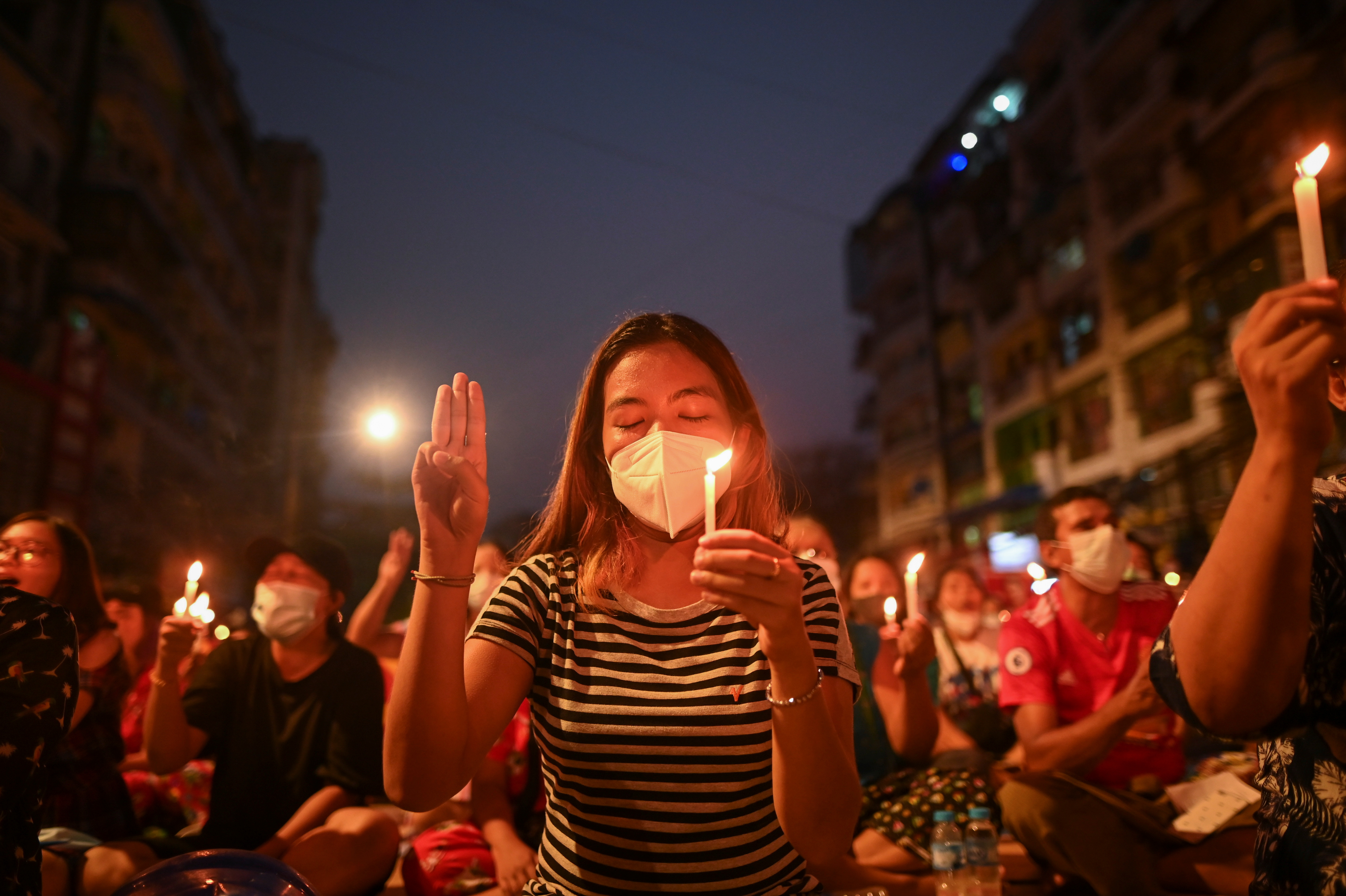 With the death toll increasing, protesters have begun to hold candlelit vigils [Reuters]