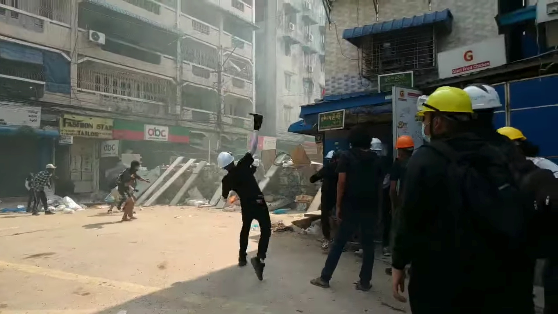 Police in Yangon were forcing people to clear protesters’ barricades on Friday