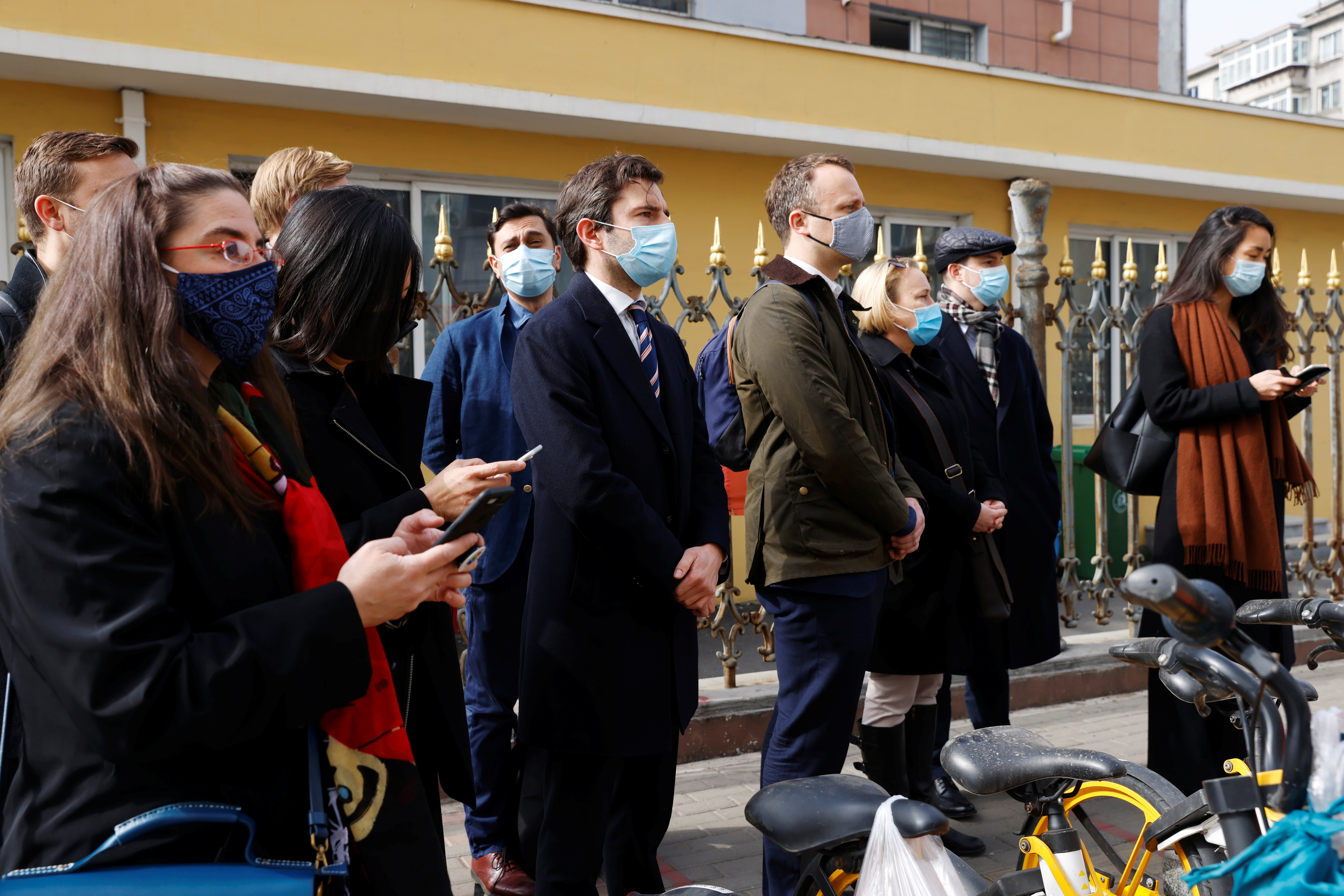 Foreign diplomats wait outside the Intermediate People’s Court where Michael Spavor is expected to stand trial, in Dandong, Liaoning province on Friday