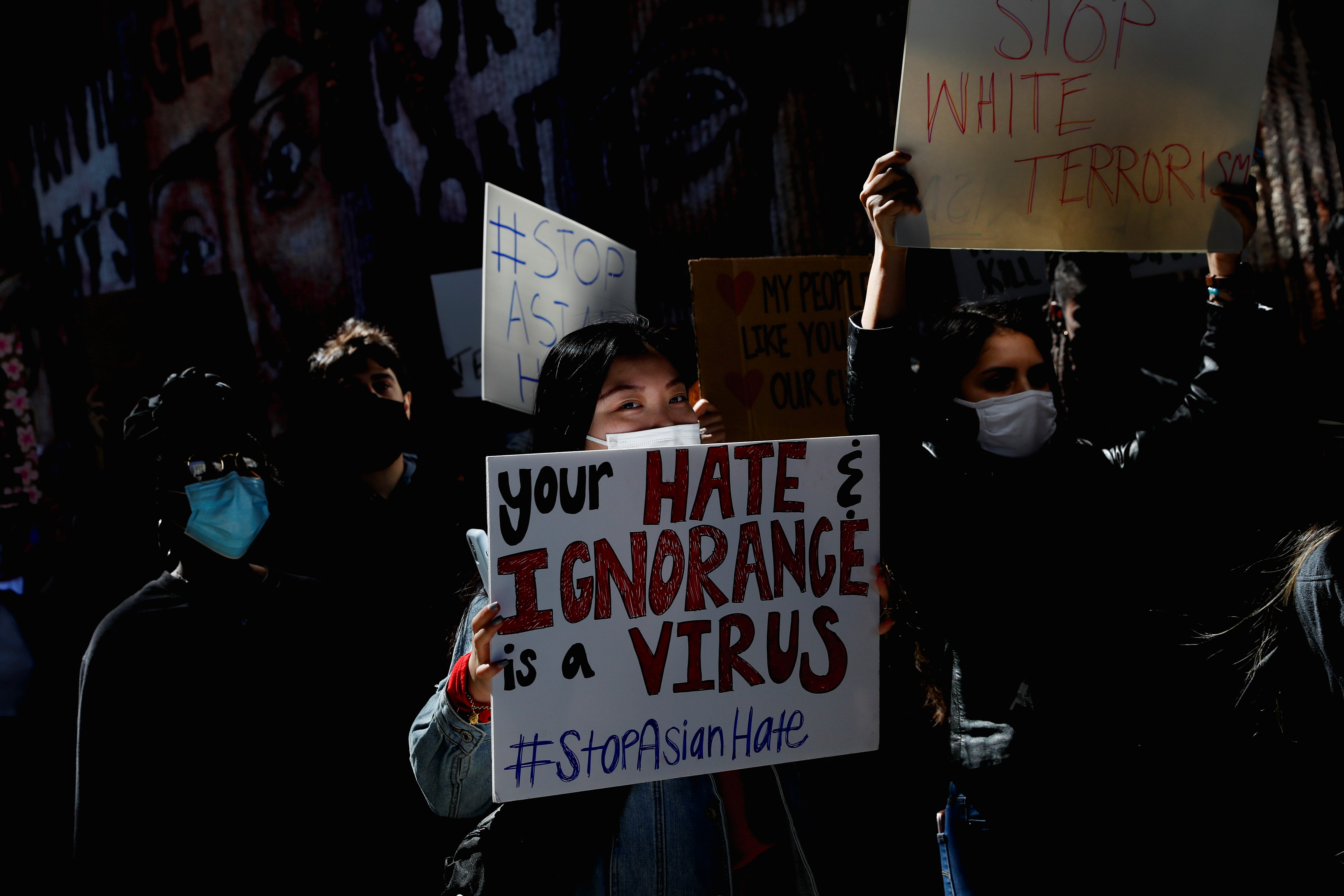 People hold placards during a ‘Stop Asian Hate’ rally, in Atlanta on March 20