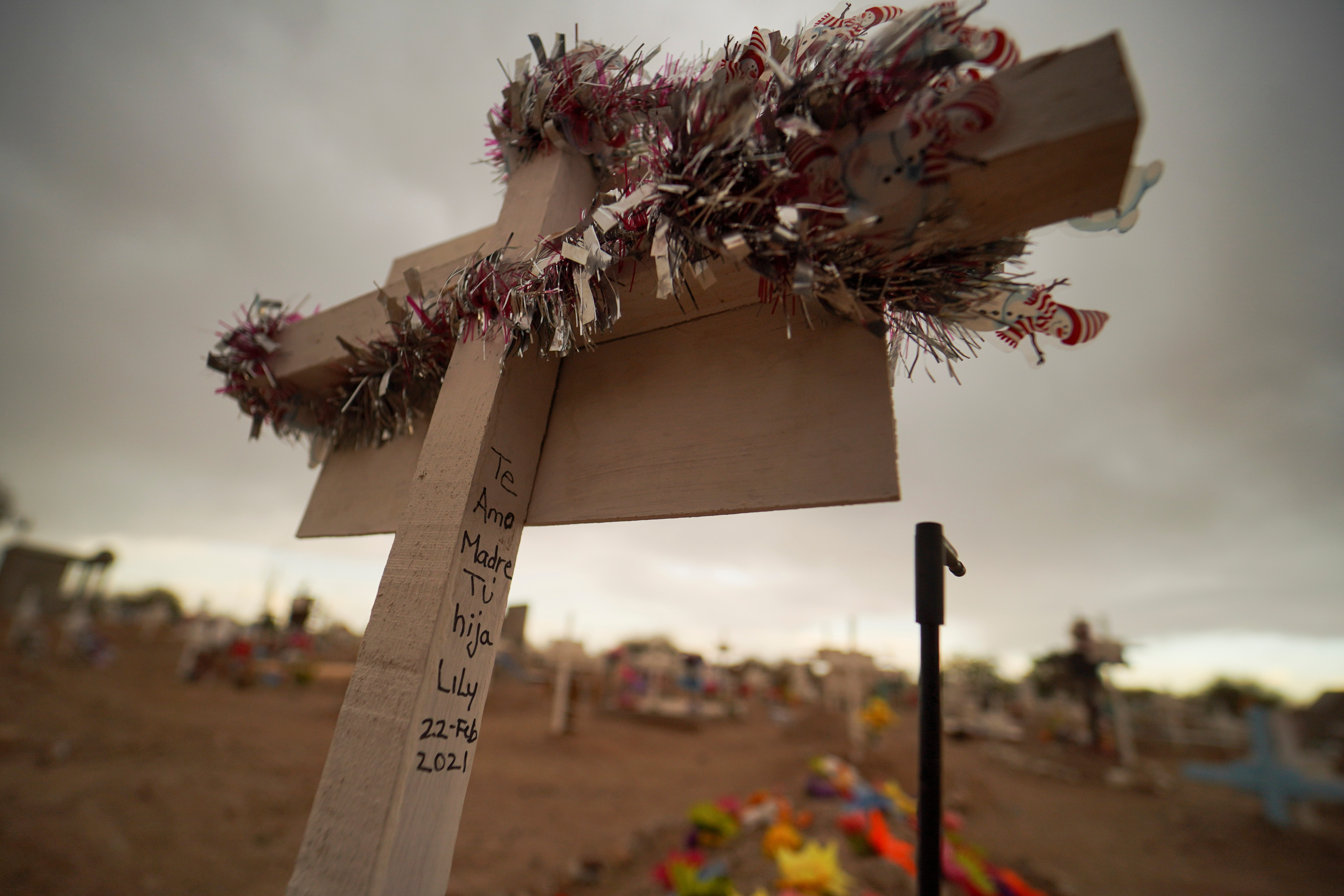 A wooden cross at El Centinela cemetery in Mexicali, Mexico. The message on the cross reads: ‘I love you, mother – your daughter Lily’