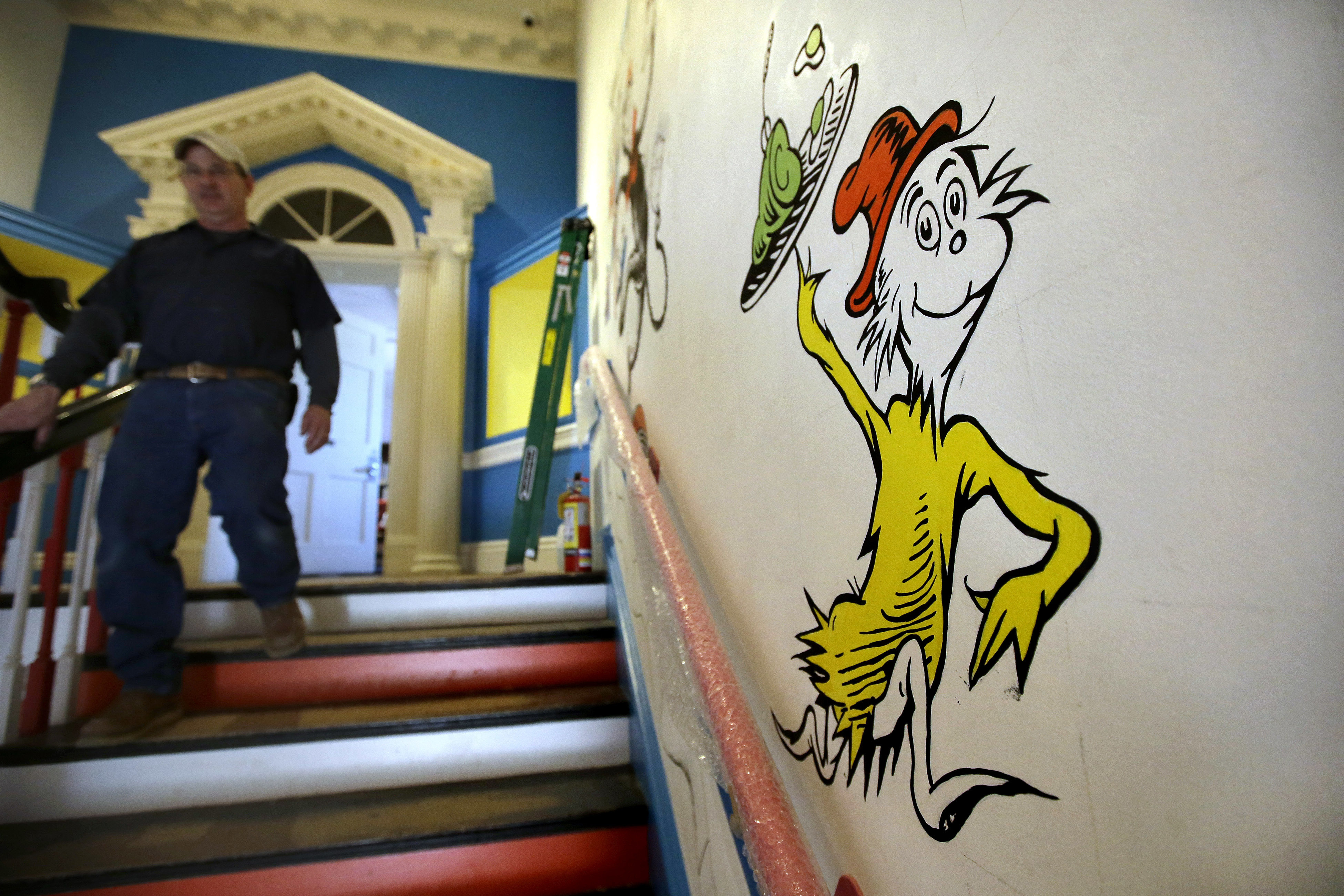 A man walks past a mural with the character ‘Sam-I-Am’ from the Dr Seuss book Green Eggs and Ham at The Amazing World of Dr Seuss Museum, in Springfield, Massachusetts