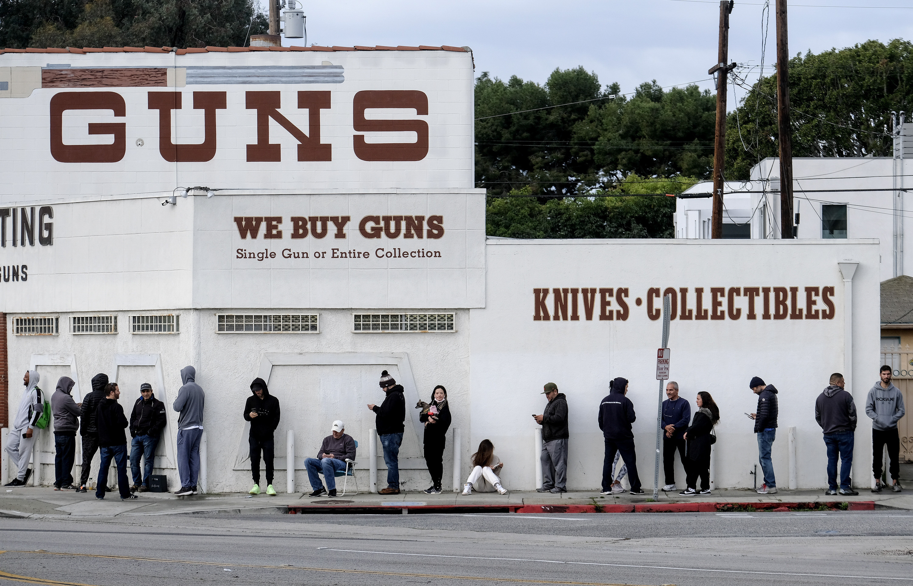 People wait in line to enter a gun store in Culver City, California, the United States