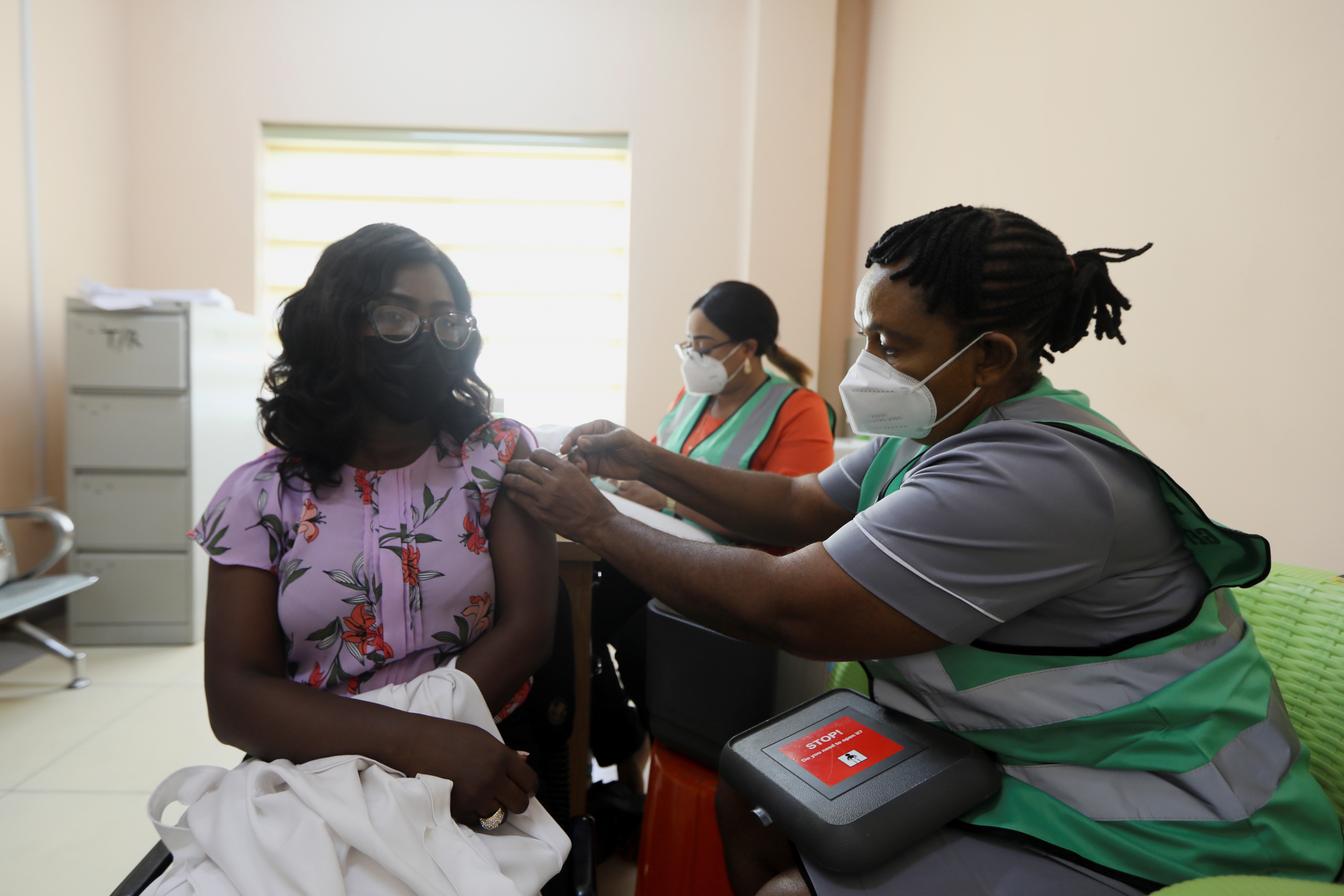 A person receives a dose of the Oxford/AstraZeneca coronavirus vaccine at the national hospital in Abuja, Nigeria