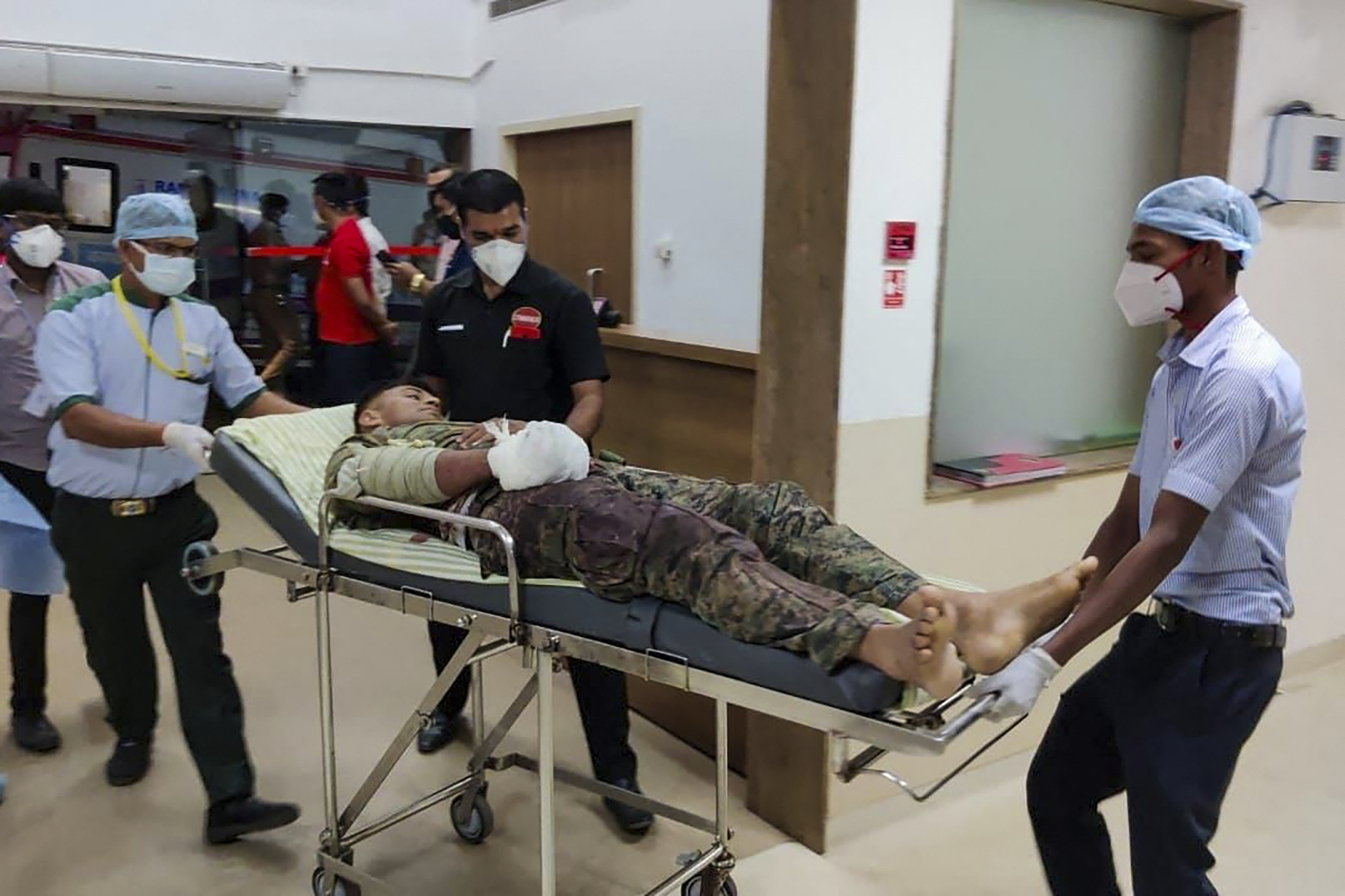 Medical workers bring an injured soldier on a stretcher for treatment in a hospital in Bijapur following a gun battle with Maoist rebels [AFP]