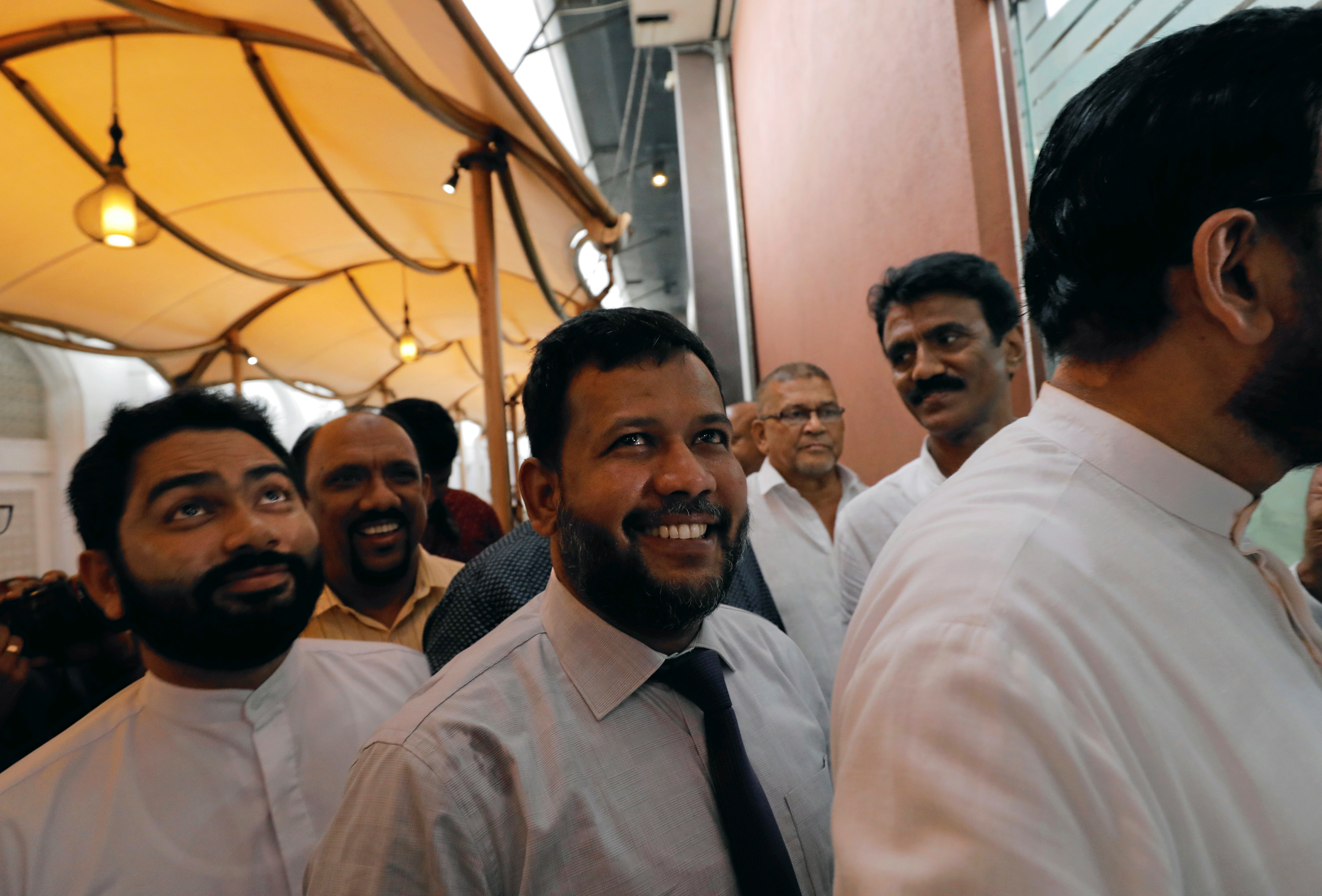 Bathiudeen (center), leader of the All Ceylon Makkal Party, was taken into custody on Saturday under the Prevention of Terrorism Act [File: Dinuka Liyanawatte/Reuters]