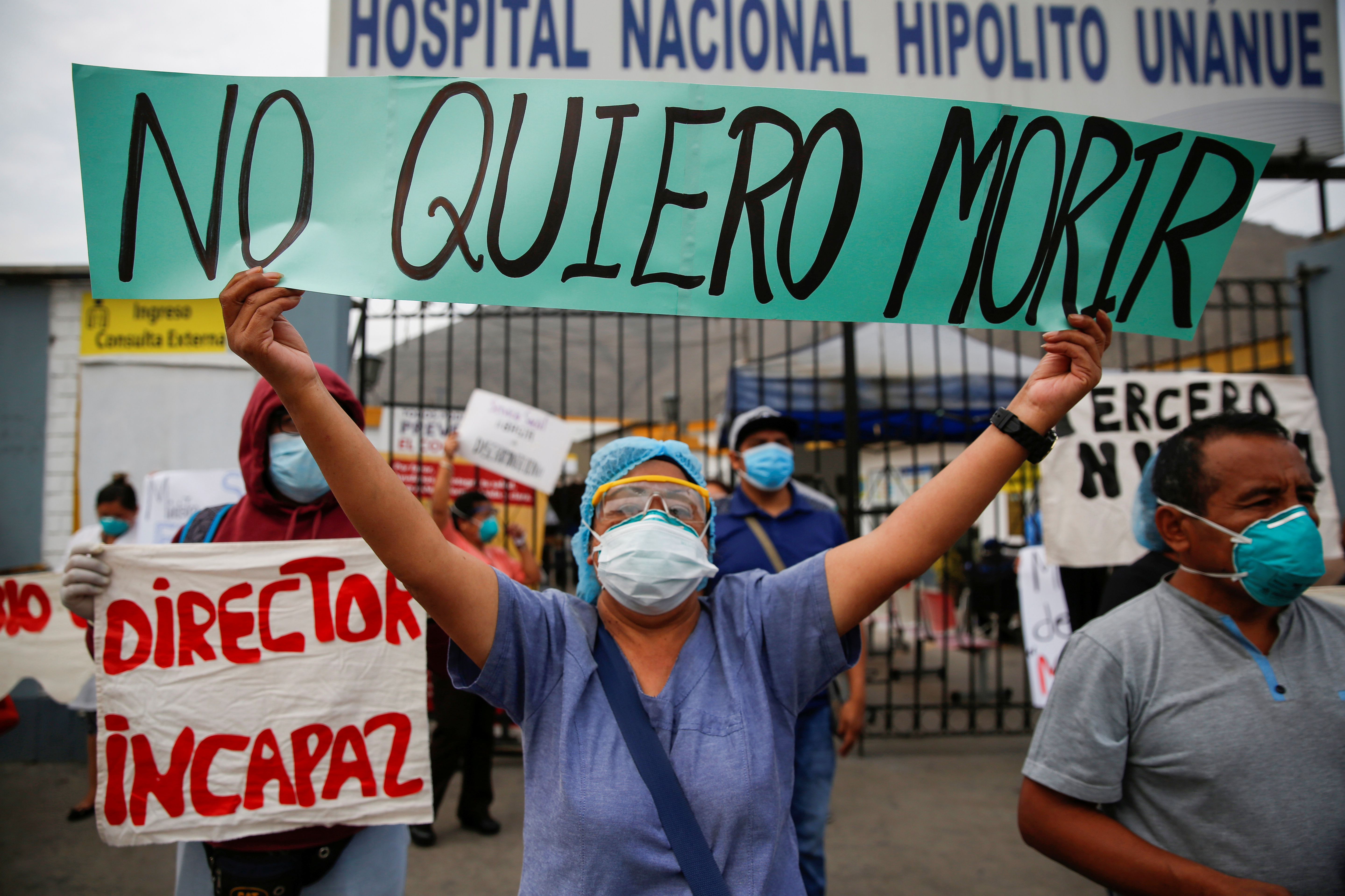 A healthcare worker holds a sign reading ‘I don’t want to die’ while protesting the lack of proper medical supplies outside of Hipolito Unanue Hospital in Lima in May last year