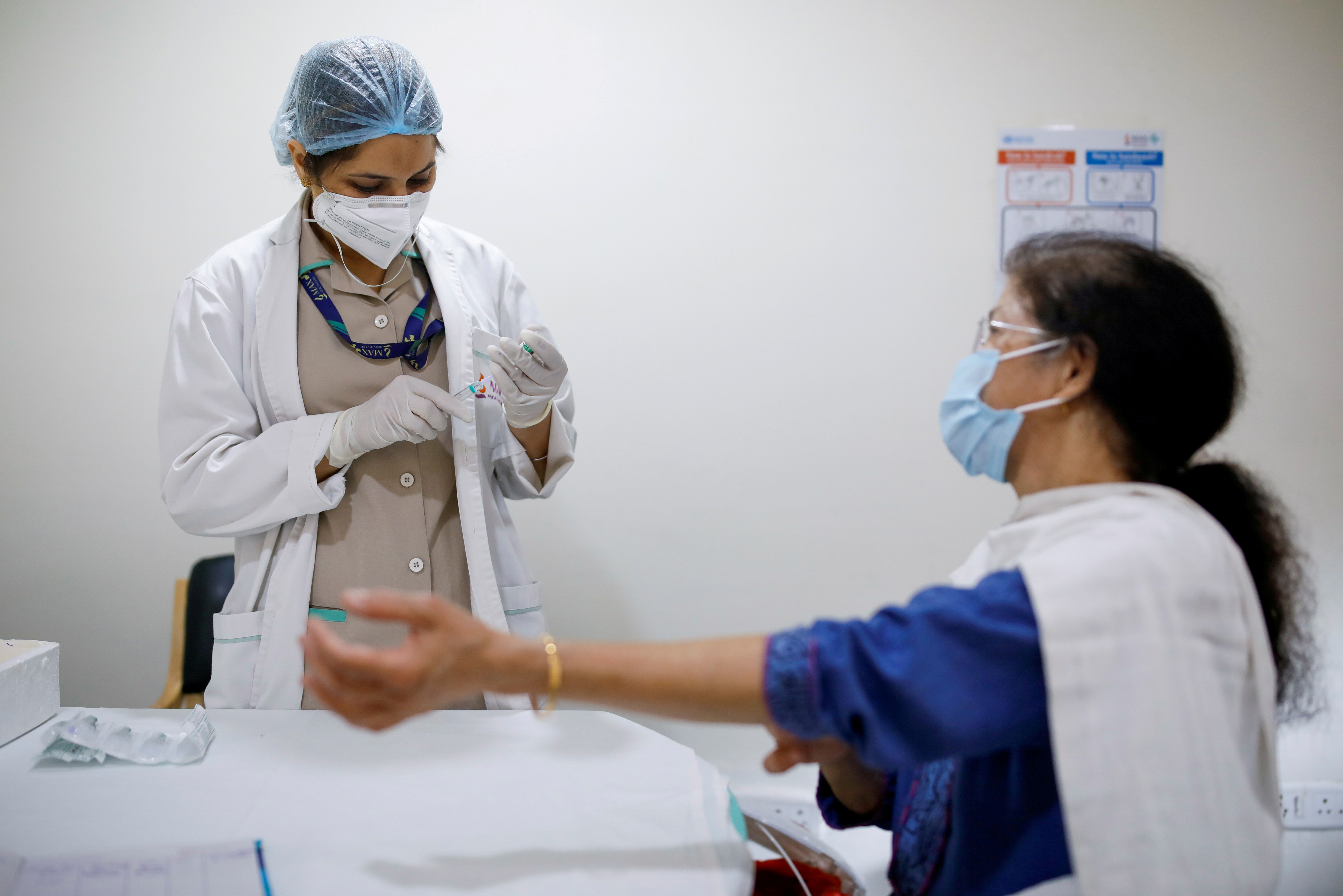 A healthcare worker prepares to administer a dose of COVISHIELD, the vaccine manufactured by the Serum Institute of India, at a hospital in New Delhi