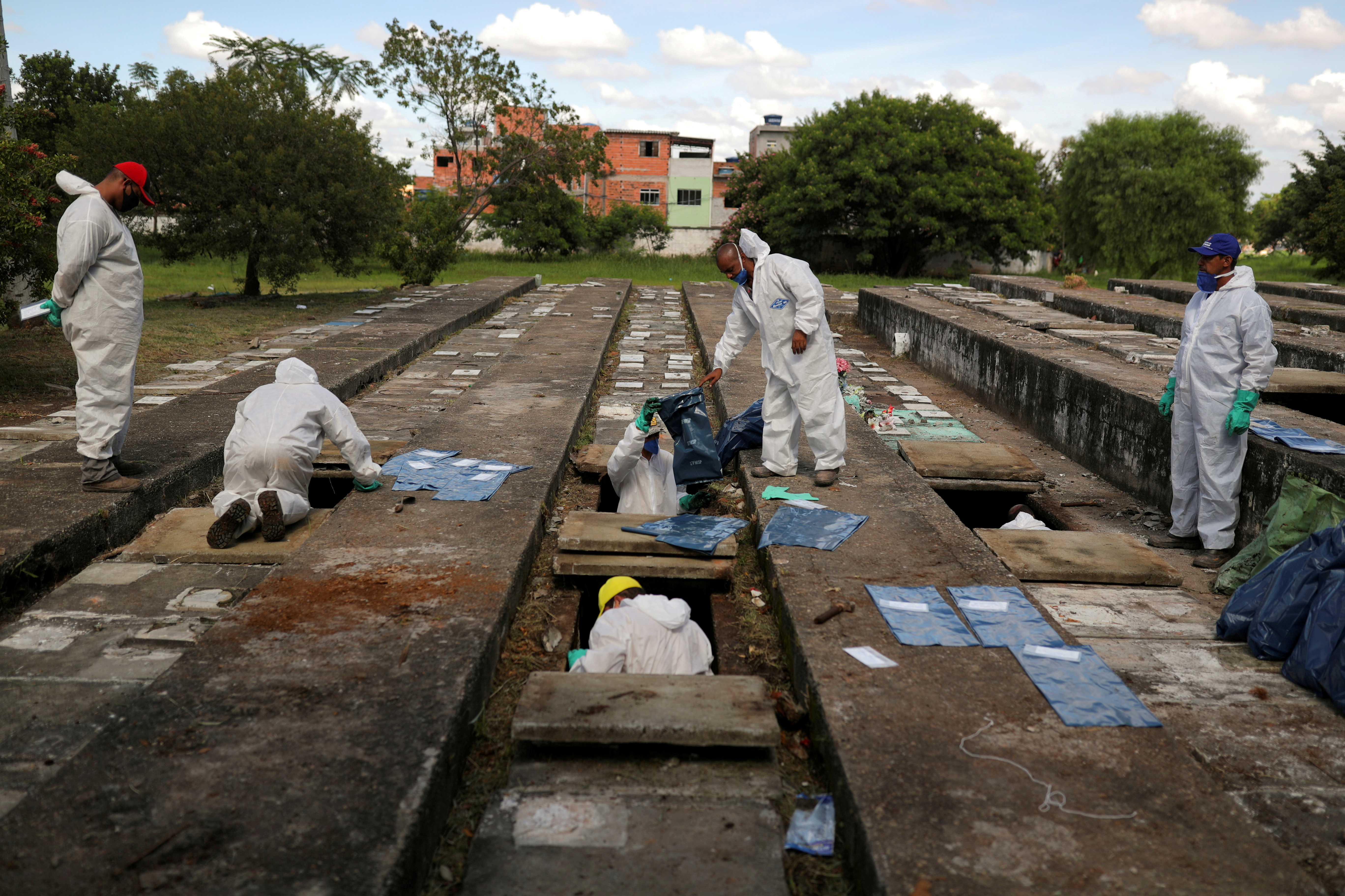 Workers exhuming old graves to create more space in the cemetery