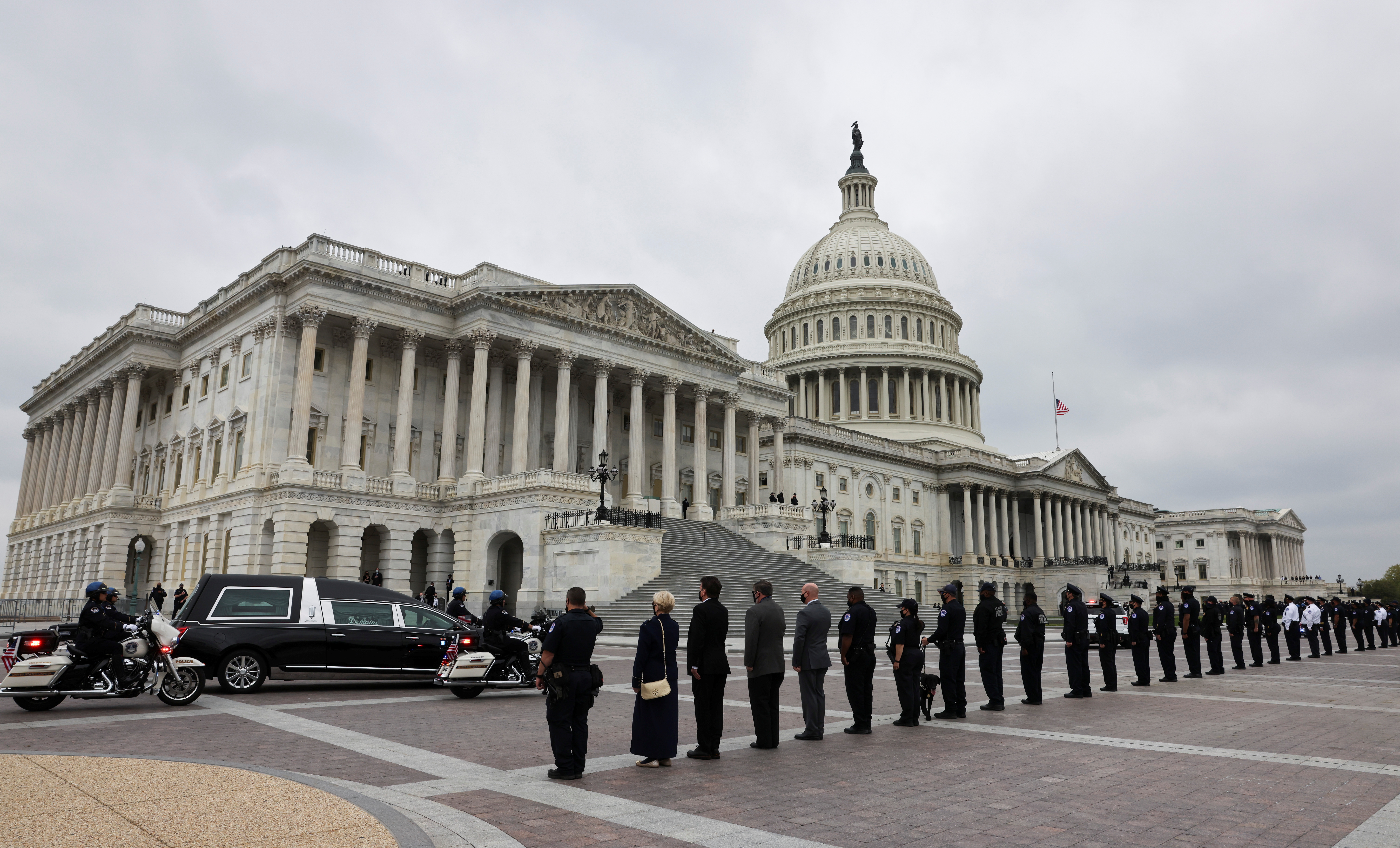 A hearse containing the remains of late US Capitol Police officer William Evans arrives for a ceremony honouring the officer as members of the Capitol Police force and staff line the plaza at the US Capitol in Washington, DC, on April 13, 2021