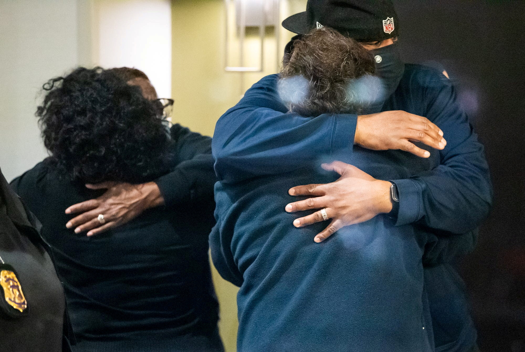 People embrace after learning that their loved one was safe after a shooting at the FedEx facility in Indianapolis, Indiana