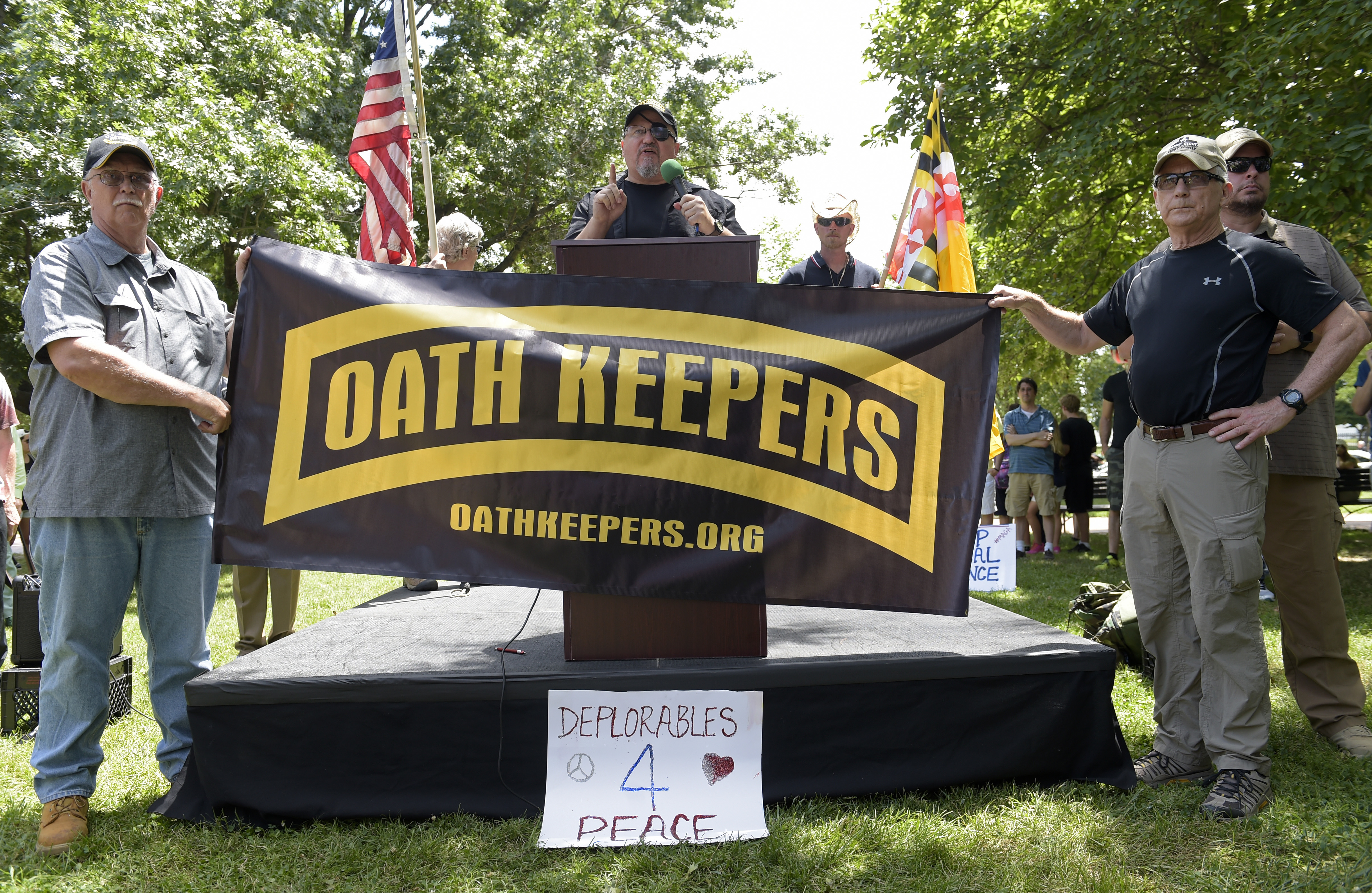 Stewart Rhodes, founder of the citizen militia group known as the Oath Keepers, center, speaks during a rally outside the White House in Washington, Sunday, June 25, 2017
