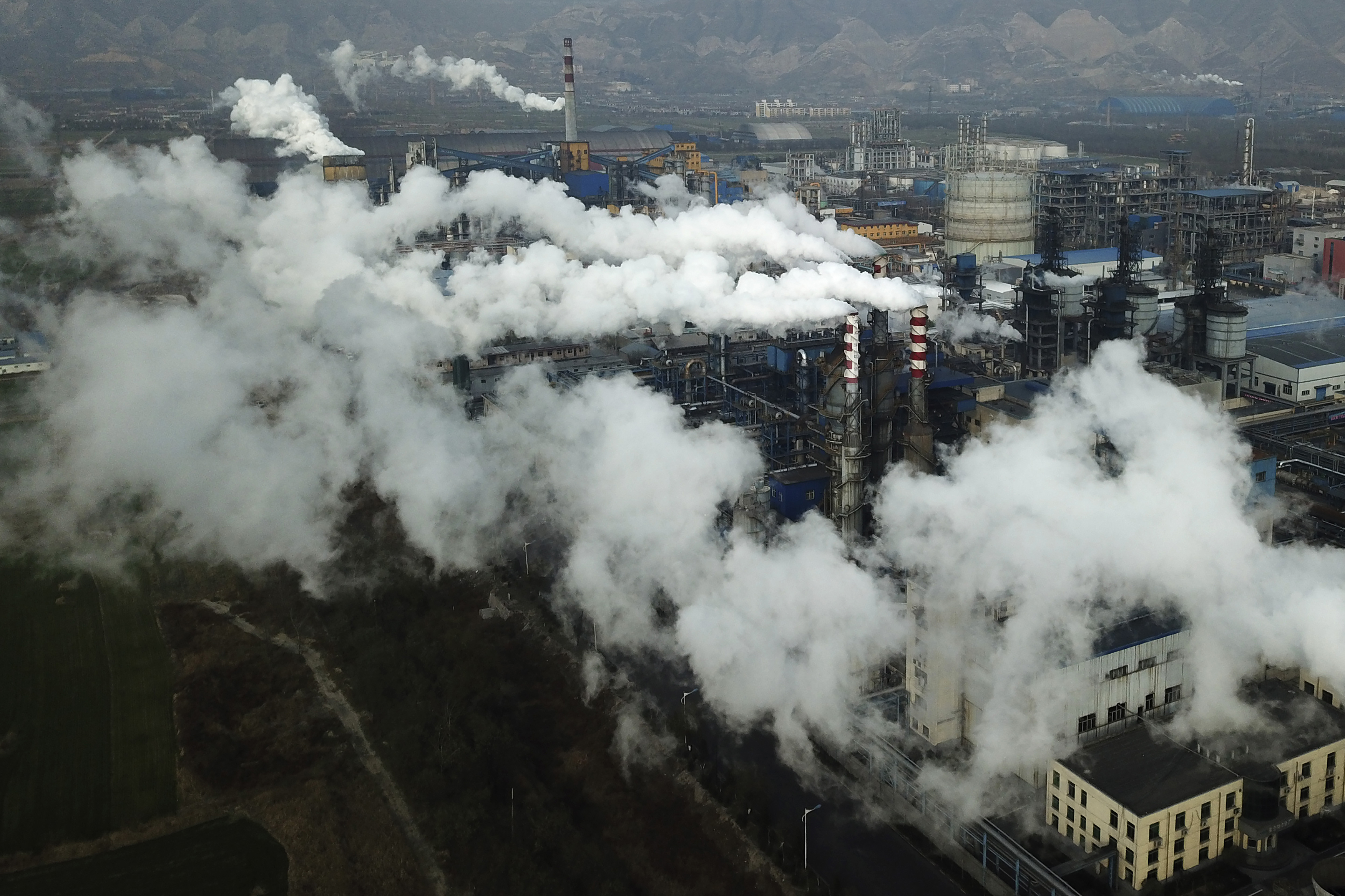 Smoke and steam rise from a coal-processing plant in Hejin in central China’s Shanxi Province
