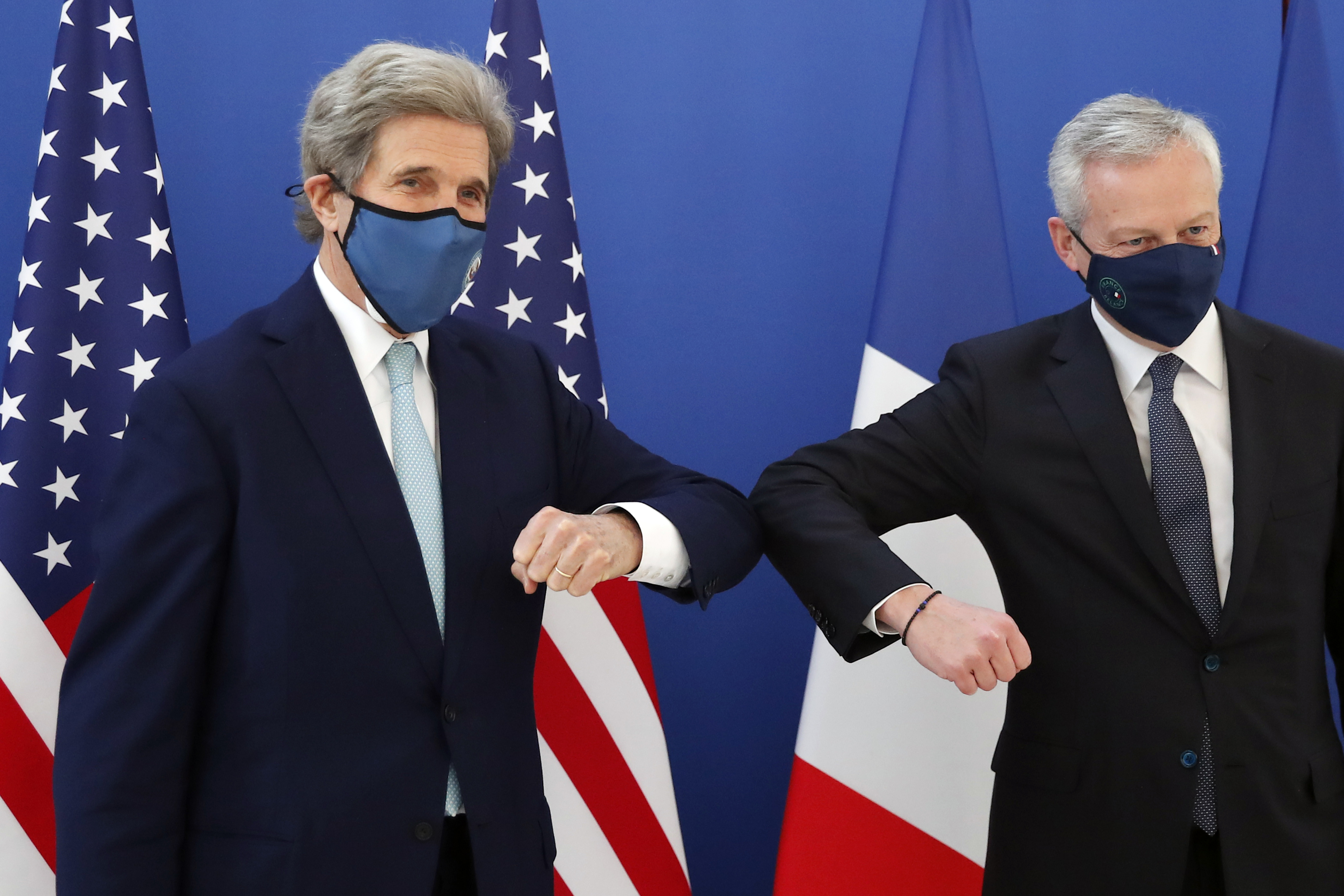 United States Special Presidential Envoy for Climate John Kerry, left, elbow bumps with France’s Economy and Finance Minister Bruno Le Maire last month when Kerry travelled to Brussels to relaunch transatlantic cooperation with European officials in the wake of President Joe Biden’s decision to rejoin the global effort to curb climate change
