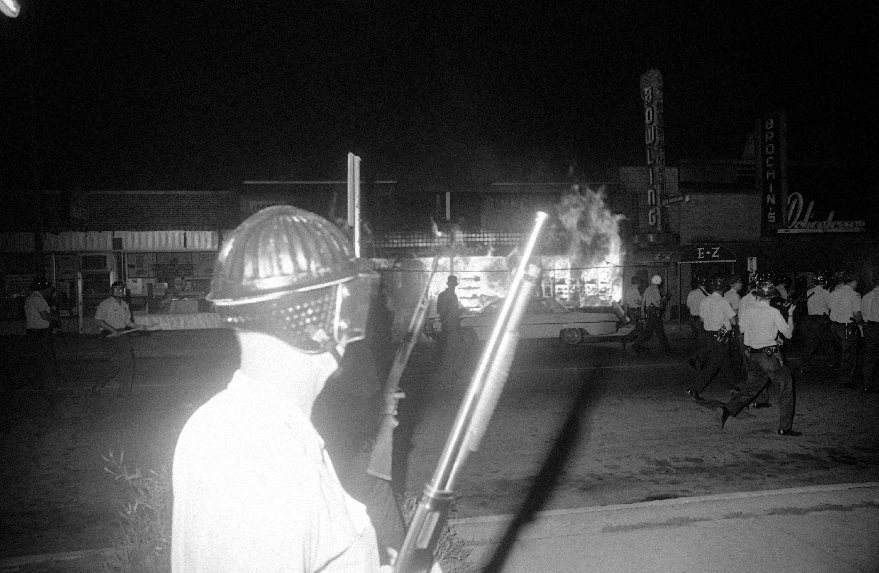 Minneapolis police armed with shotguns patrol Plymouth Ave in Minneapolis on July 21, 1967 to suppress Black uprisings