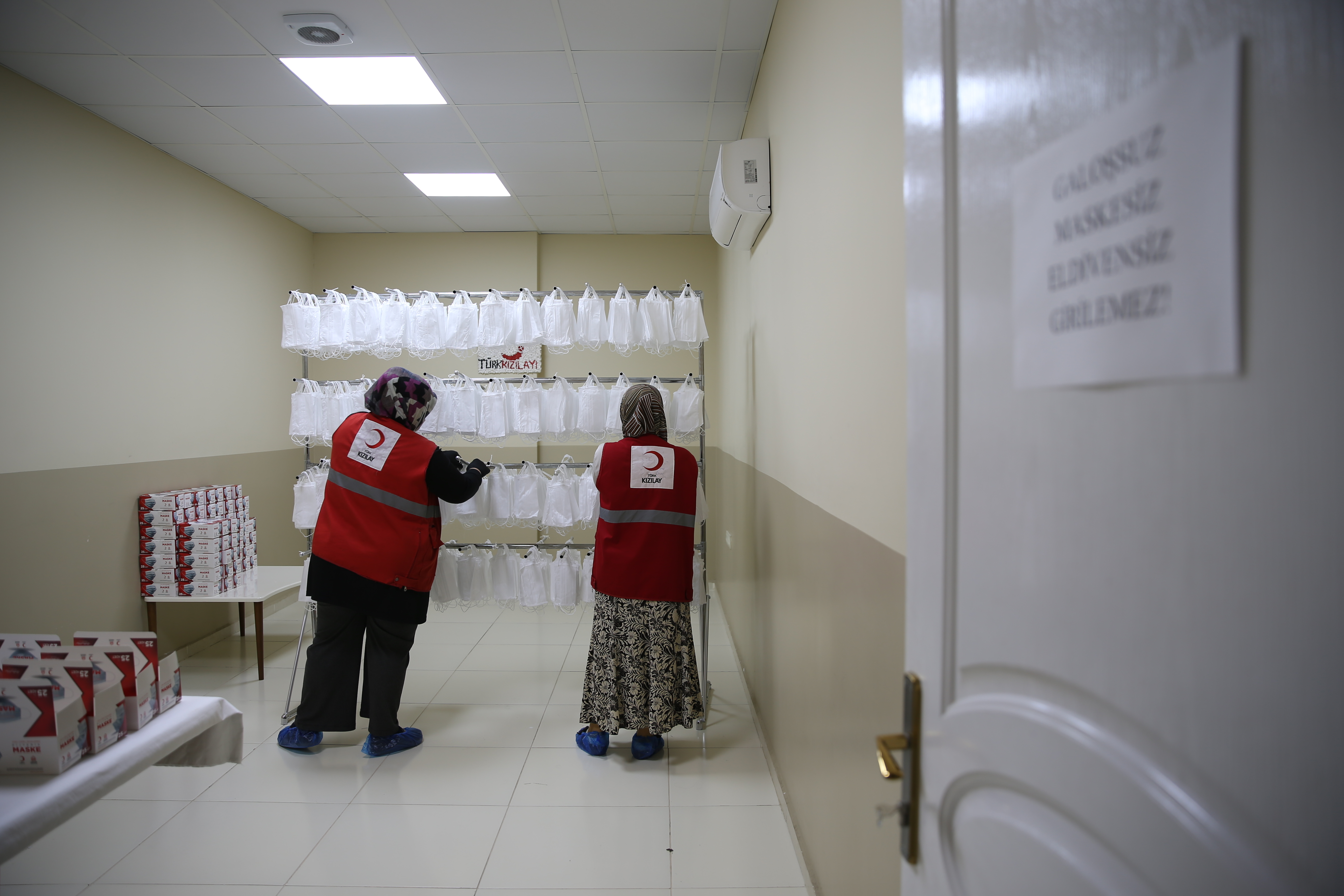 Volunteers put masks they produced in boxes at Turkish Red Crescent Community Center in Hatay, Turkey on August 20, 2020. [Cem Genco/Anadolu Agency via Getty Images] (Anadolu)