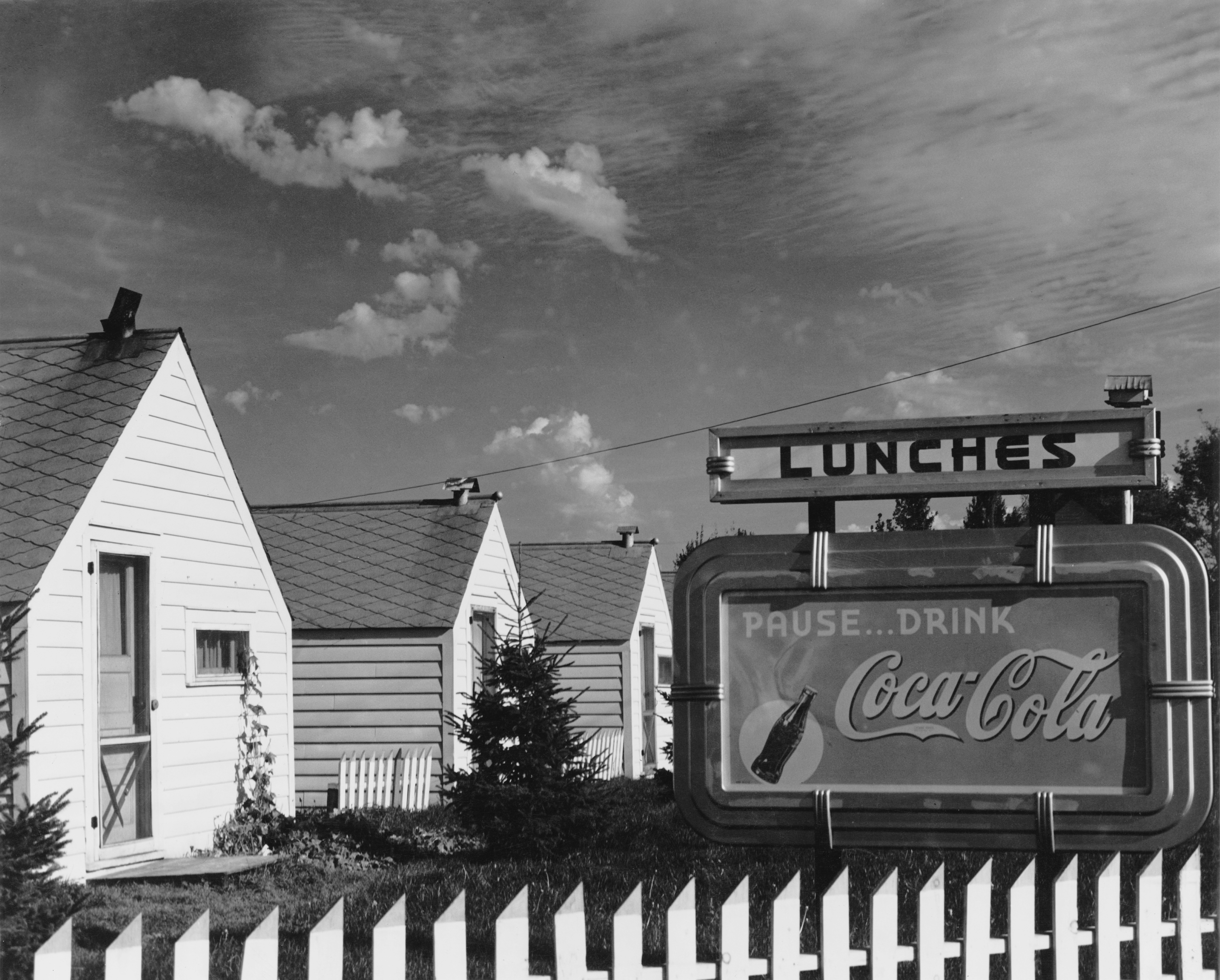 Holiday cabins in Floodwood, Minnesota, with a Coca-Cola advertisement in front, circa 1955