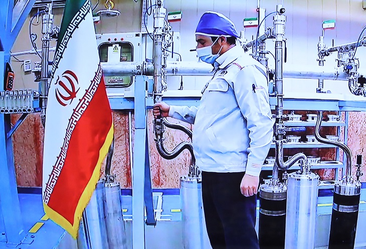 An engineer performs a mechanical test on nuclear equipment
