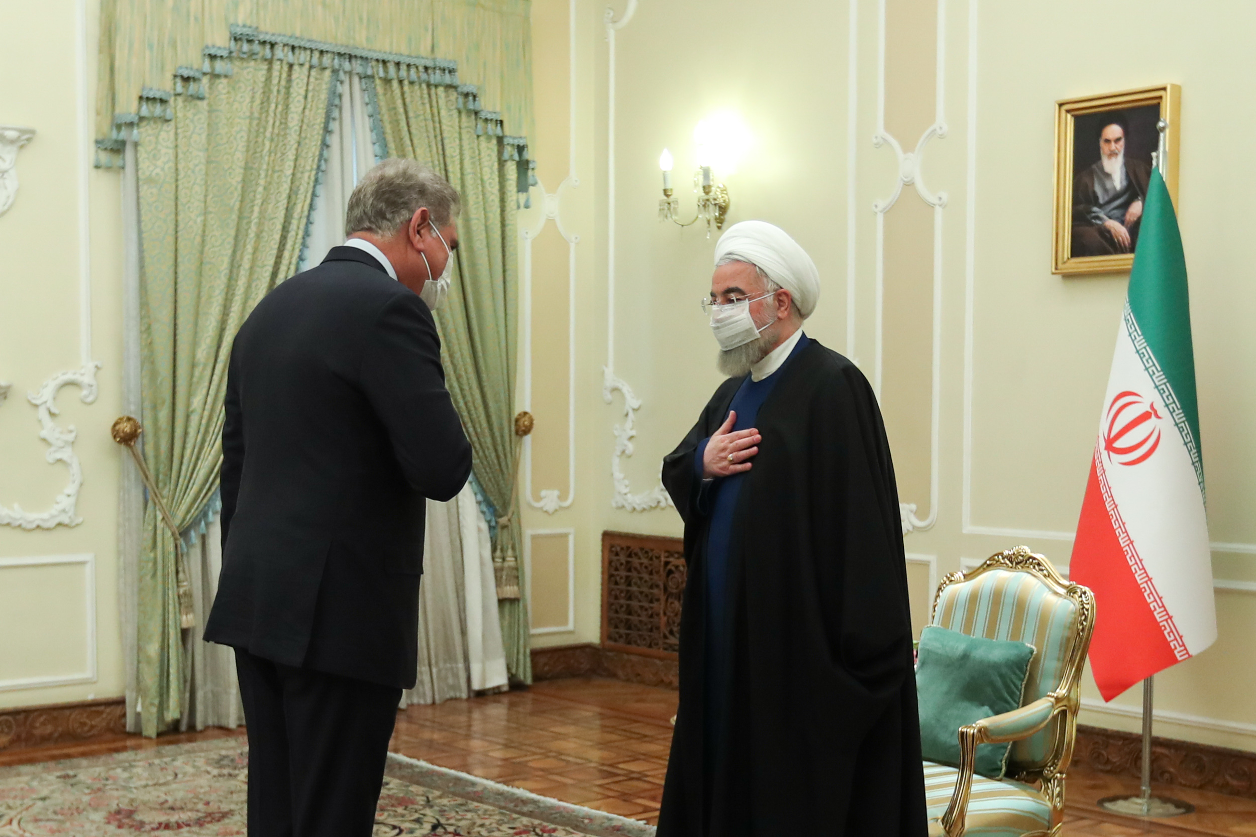 Iranian President Hassan Rouhani, right, welcomes Pakistani Foreign Minister Qureshi, at the presidential office in Tehran [Iranian presidential office handout/EPA]
