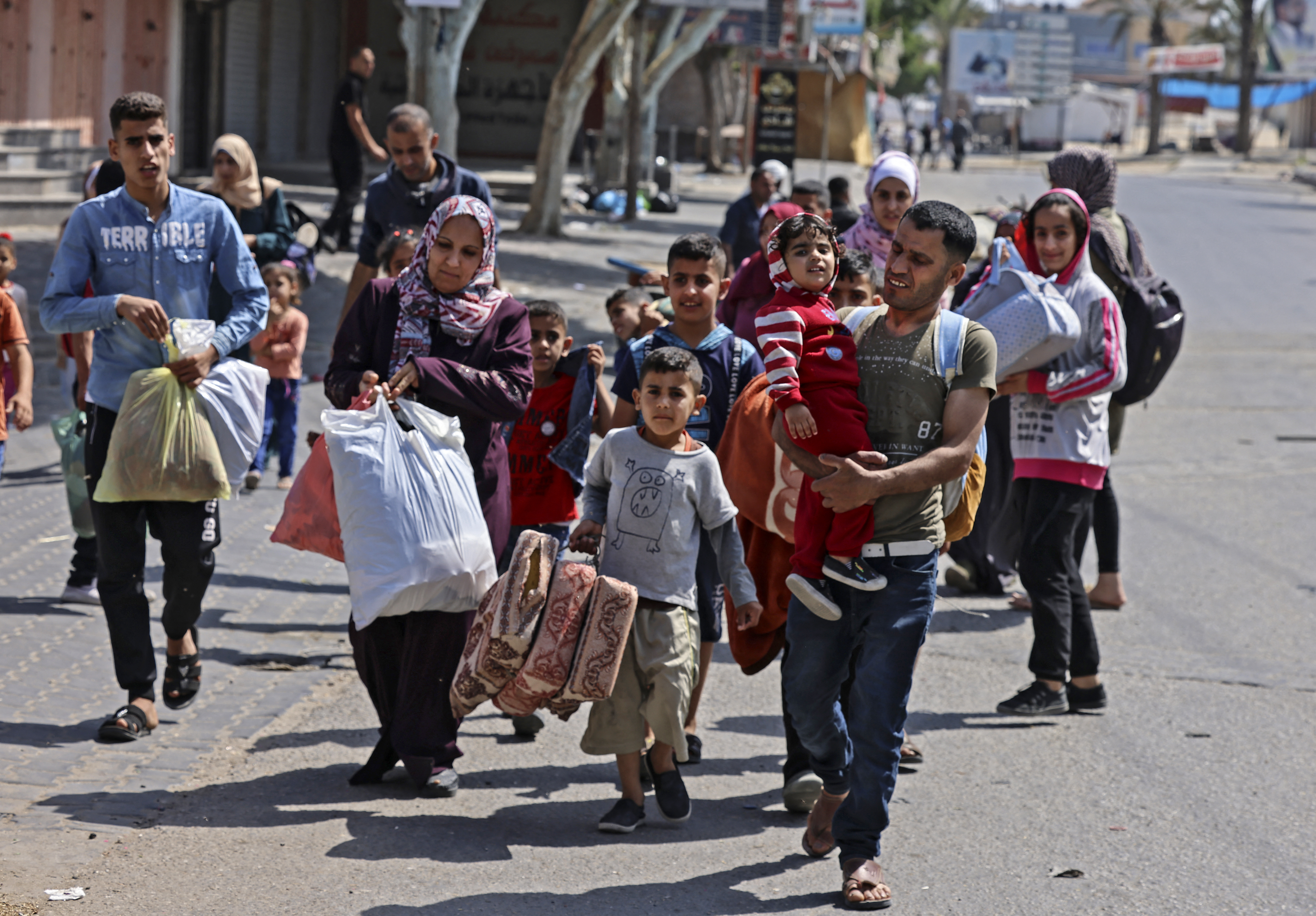 Palestinians carry some of their belongings in Beit Hanoun in the northern Gaza Strip, as they flee Israeli air and artillery attacks on Thursday
