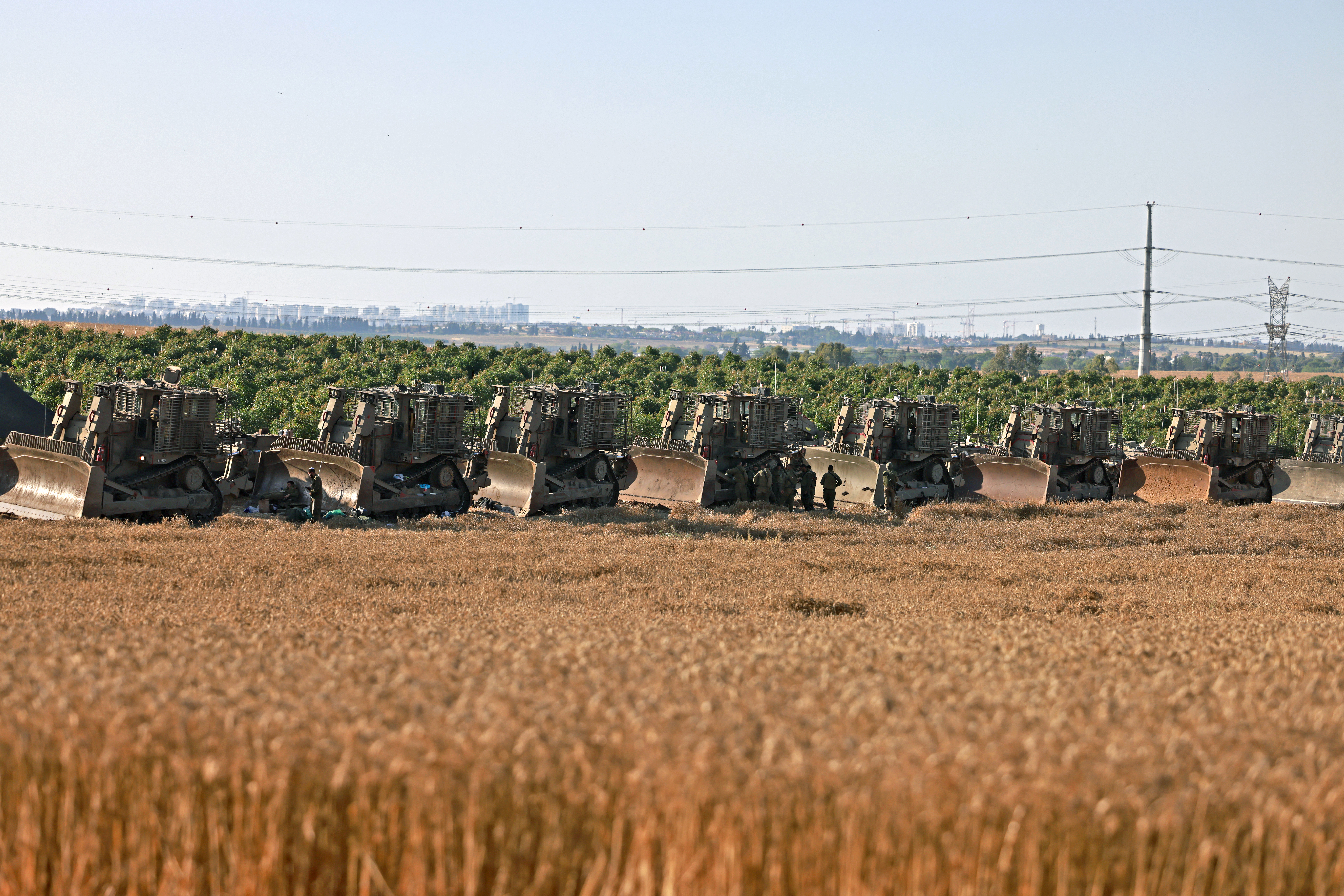 Israeli military bulldozers are seen in southern Israel along the border with the besieged Gaza Strip