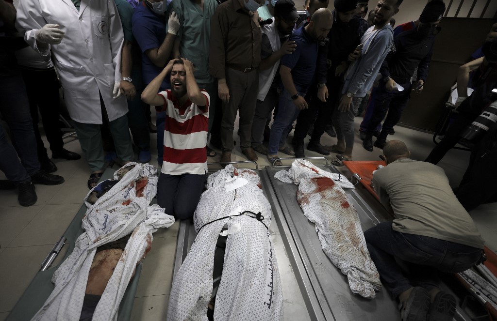 Relatives of the Abo Hatab family mourn over the bodies of their family members in Al-Shifa Hospital, after an Israeli air strike struck their house located in al-Shati Refugee Camp without warning late on Friday