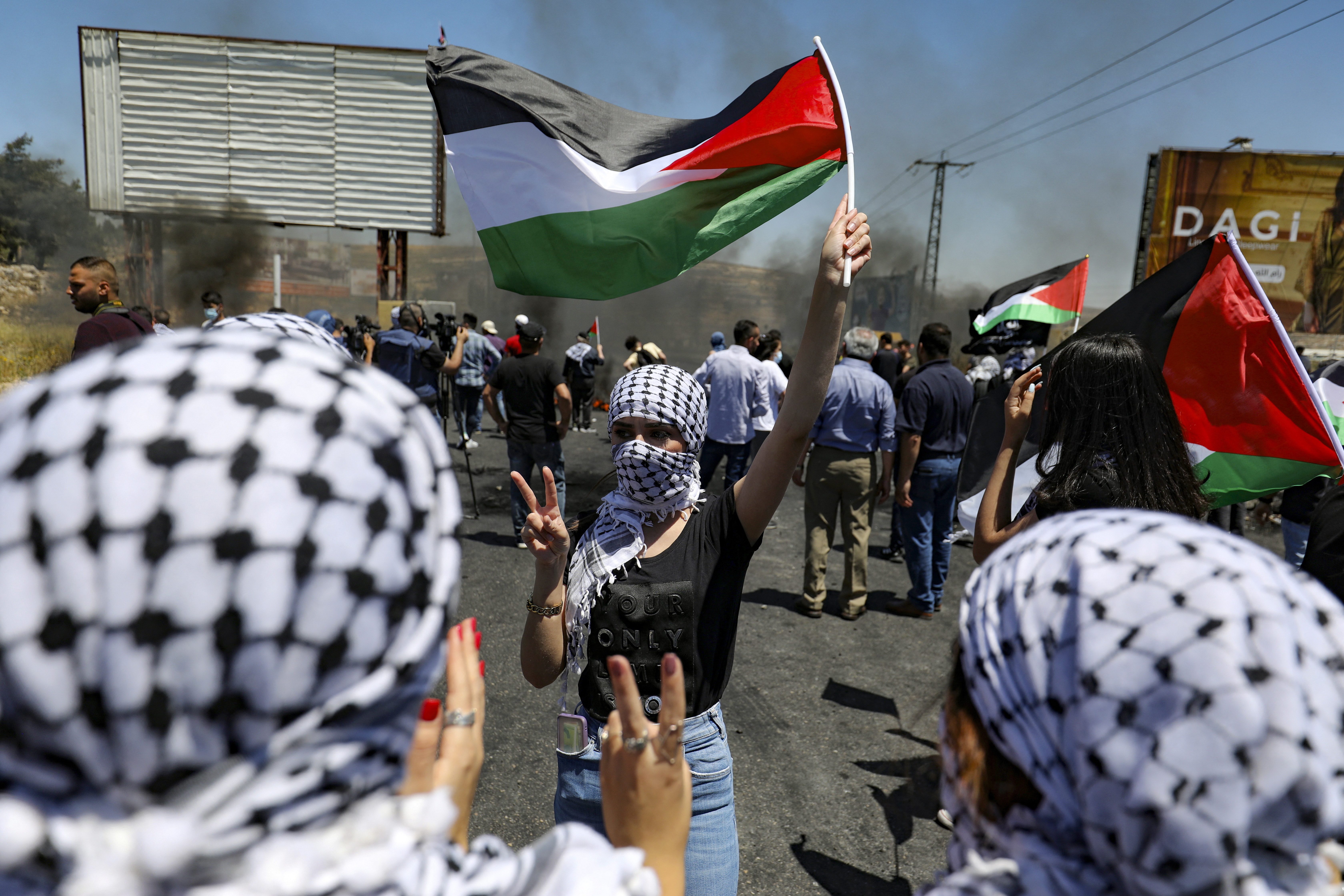 Young Palestinian women take part in a protest near the illegal Israeli settlement of Beit El, near Ramallah in the occupied West Bank, on May 15, 2021