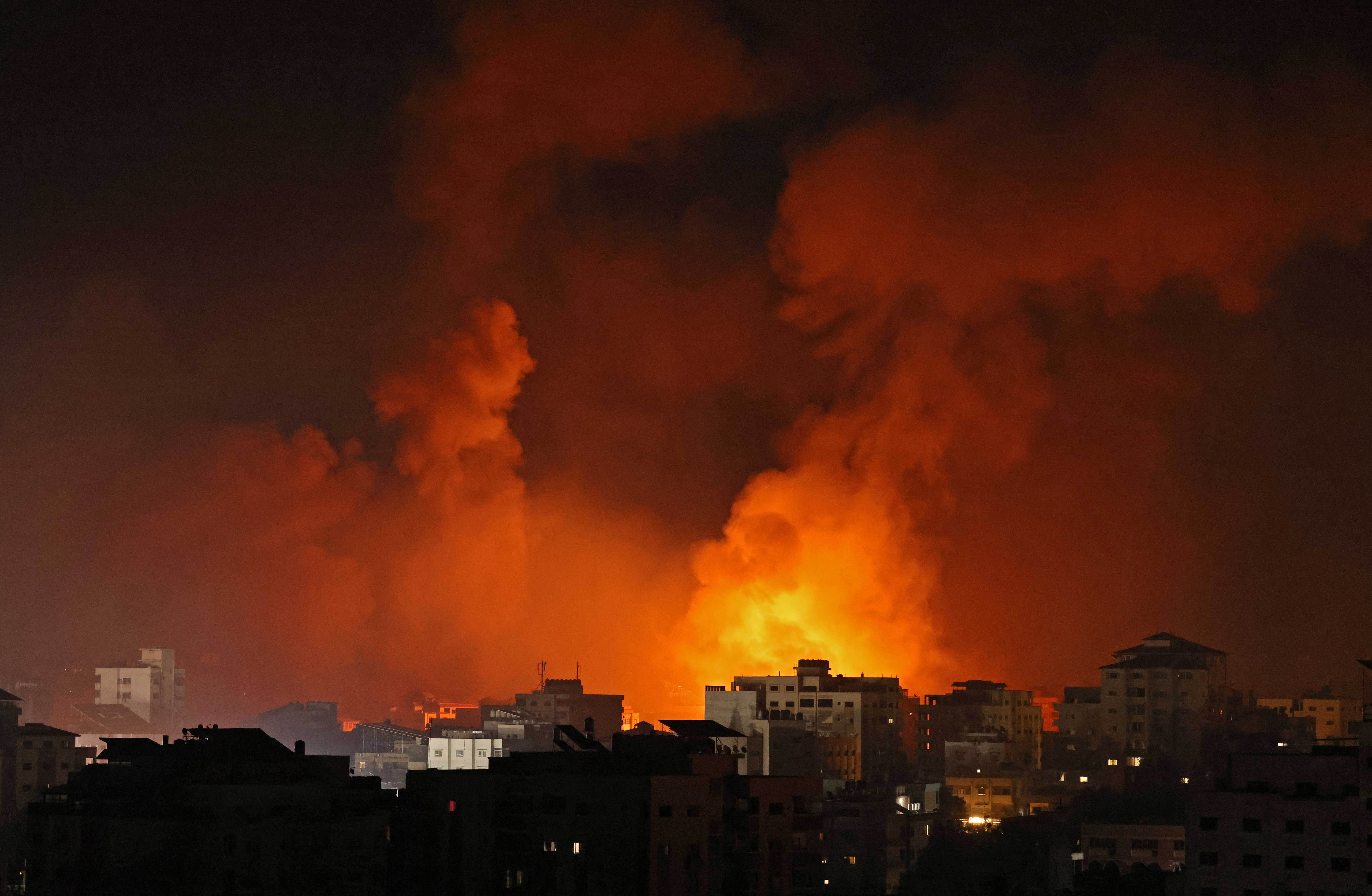 Smoke billows from a fire following Israeli air raids on multiple targets in Gaza City, controlled by the Palestinian Hamas movement, early on May 16, 2021