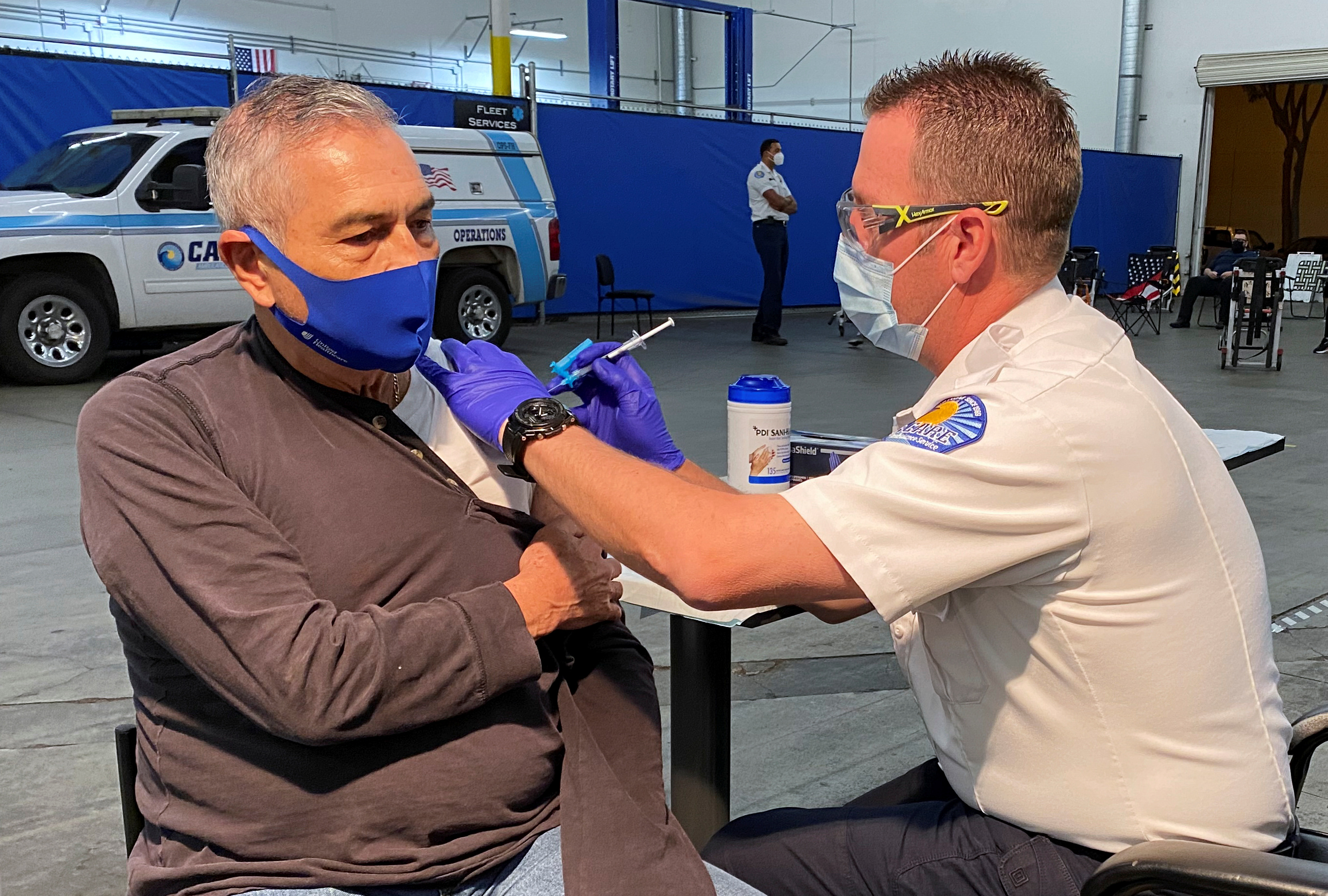 Jose Luis Espinoza, 68, receives a dose of the Pfizer vaccination against COVID-19 after waiting for a leftover one at a clinic in Santa Fe Springs, California on February 2, 2021