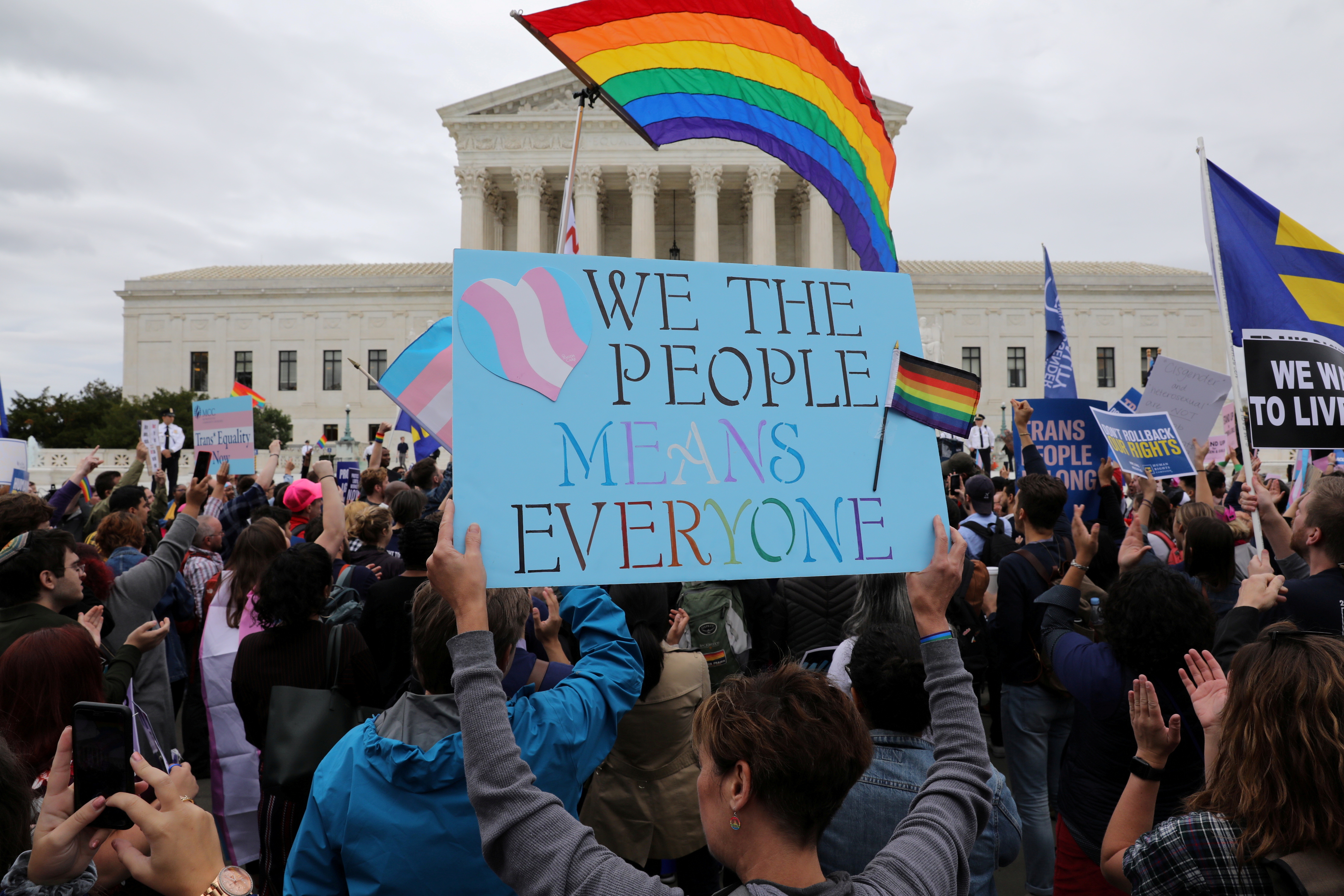 LGBTQ activists and supporters rally outside the US Supreme Court as it hears arguments on whether a federal anti-discrimination law that bans workplace discrimination on the basis of sex covers gay and transgender employees in Washington, US