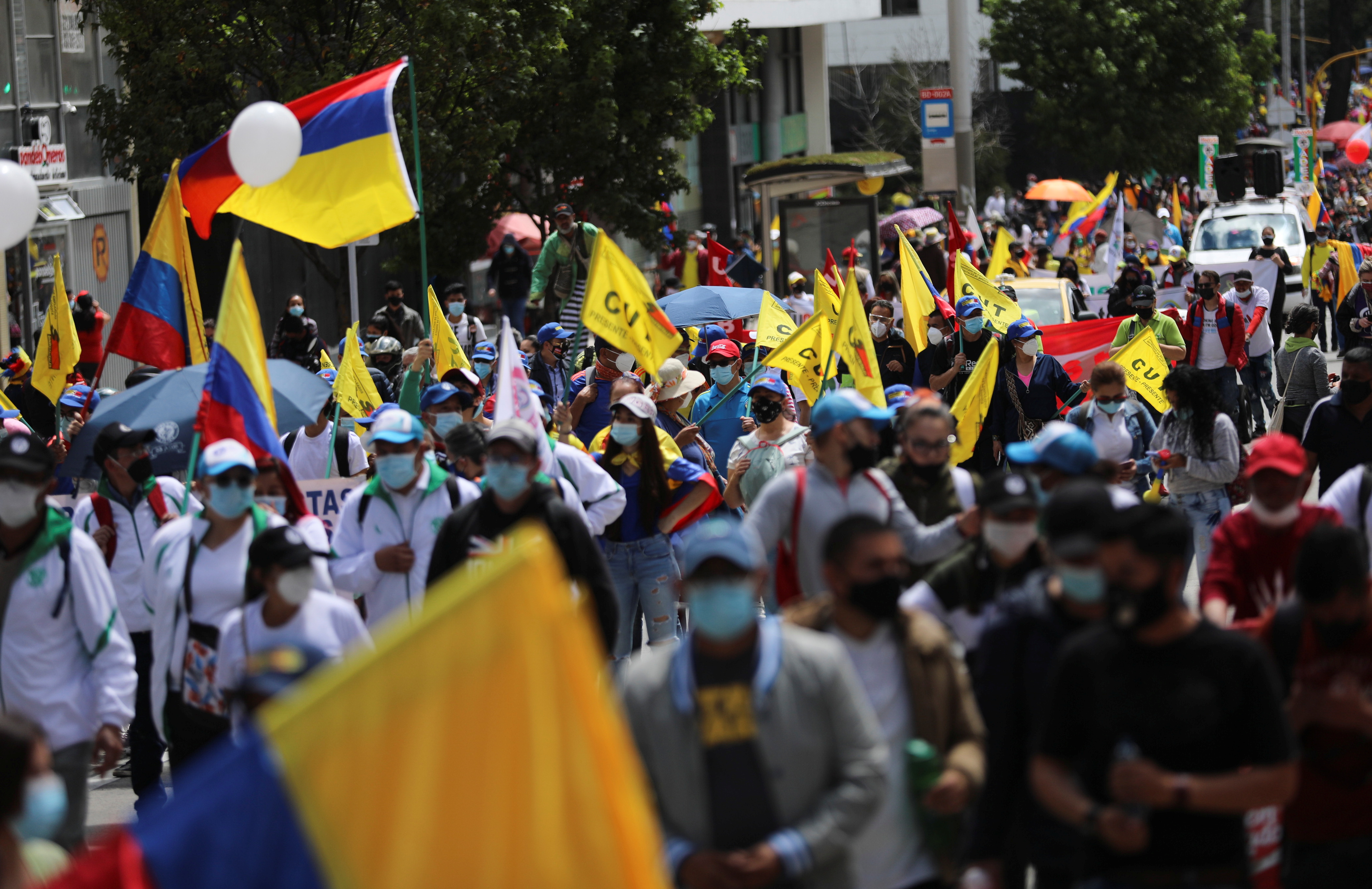 Demonstrators take part in a protest demanding government action to tackle poverty, police violence and inequalities in healthcare and education systems, in Bogota on May 19