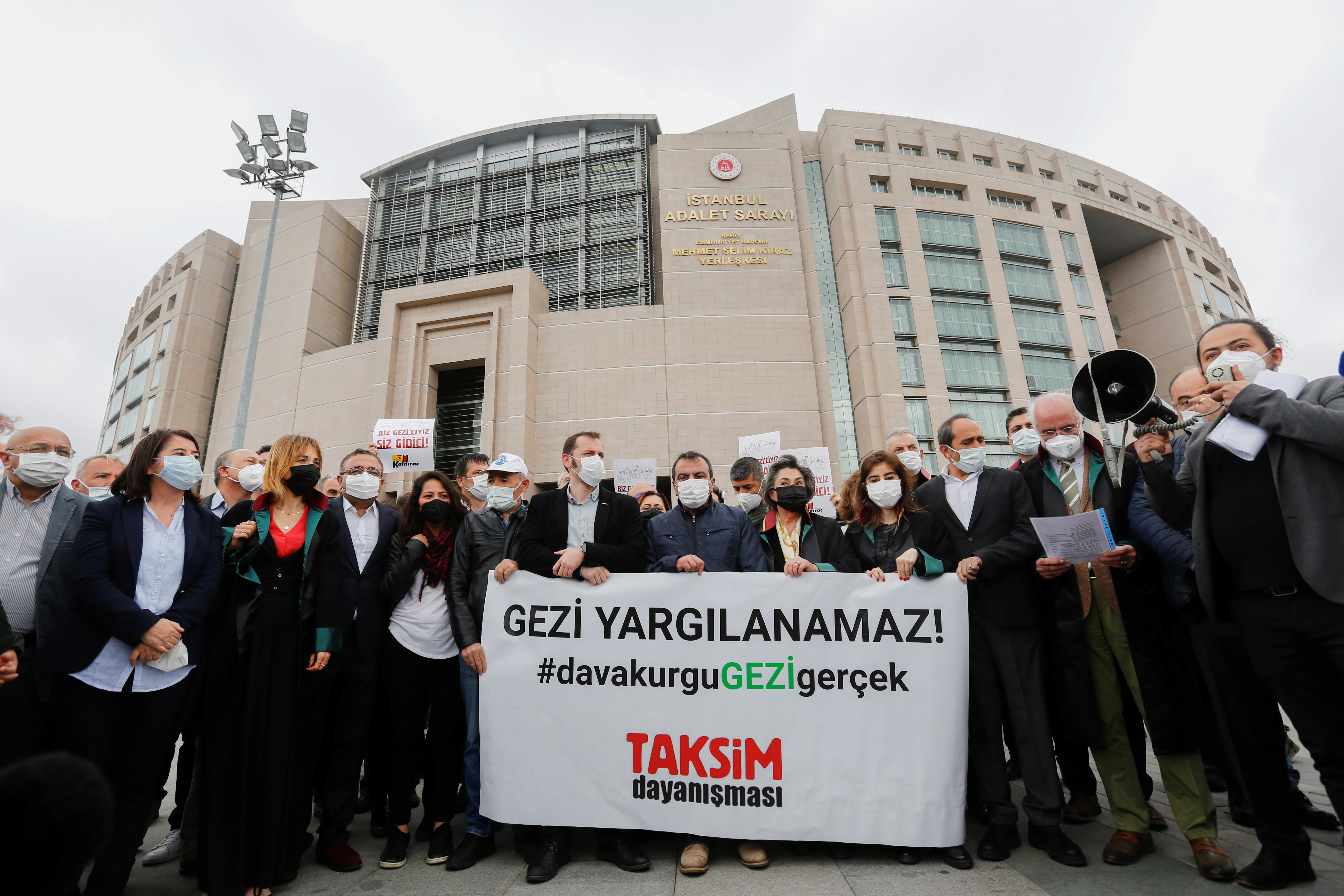 Lawyers and opposition lawmakers gather in front of the court